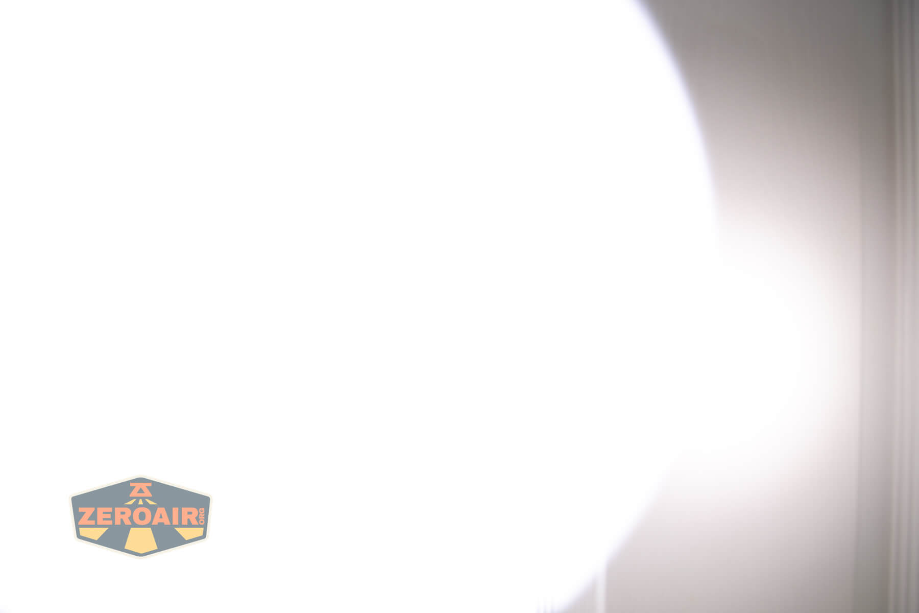 A bright white light fills most of the image, creating a washed-out effect with a soft shadow on the right. The ZeroAir logo appears in the lower left corner.