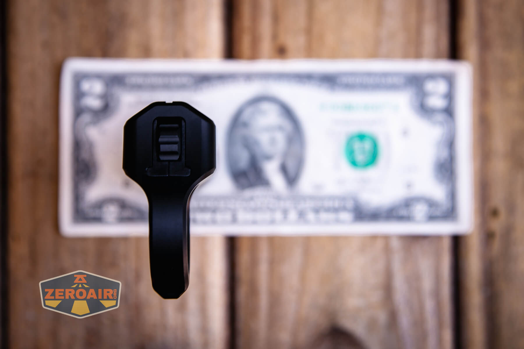 Nextorch Artorch compact EDC tactical flashlight on two dollar bill