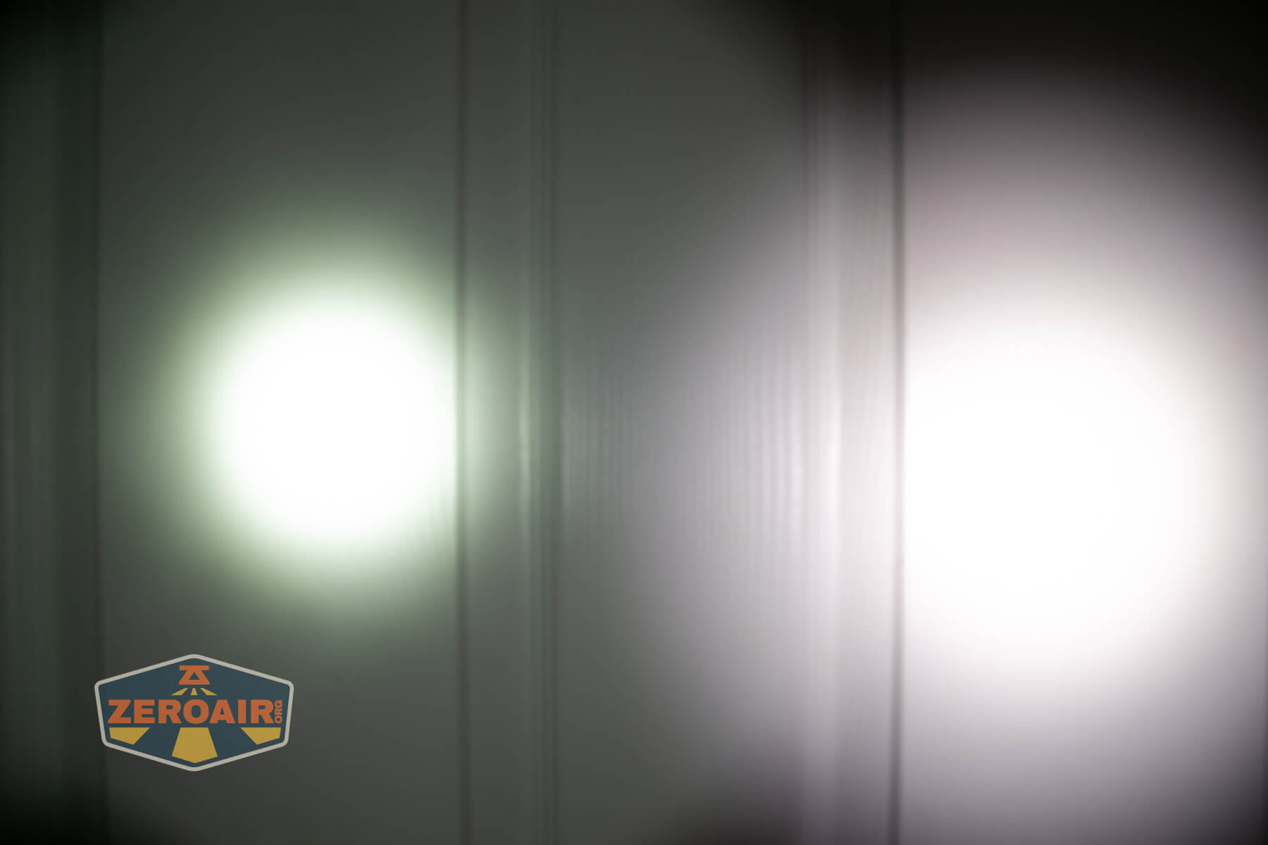 Nextorch Artorch compact EDC tactical flashlight beamshots on door (at 1') compared to nichia 219b 4500K