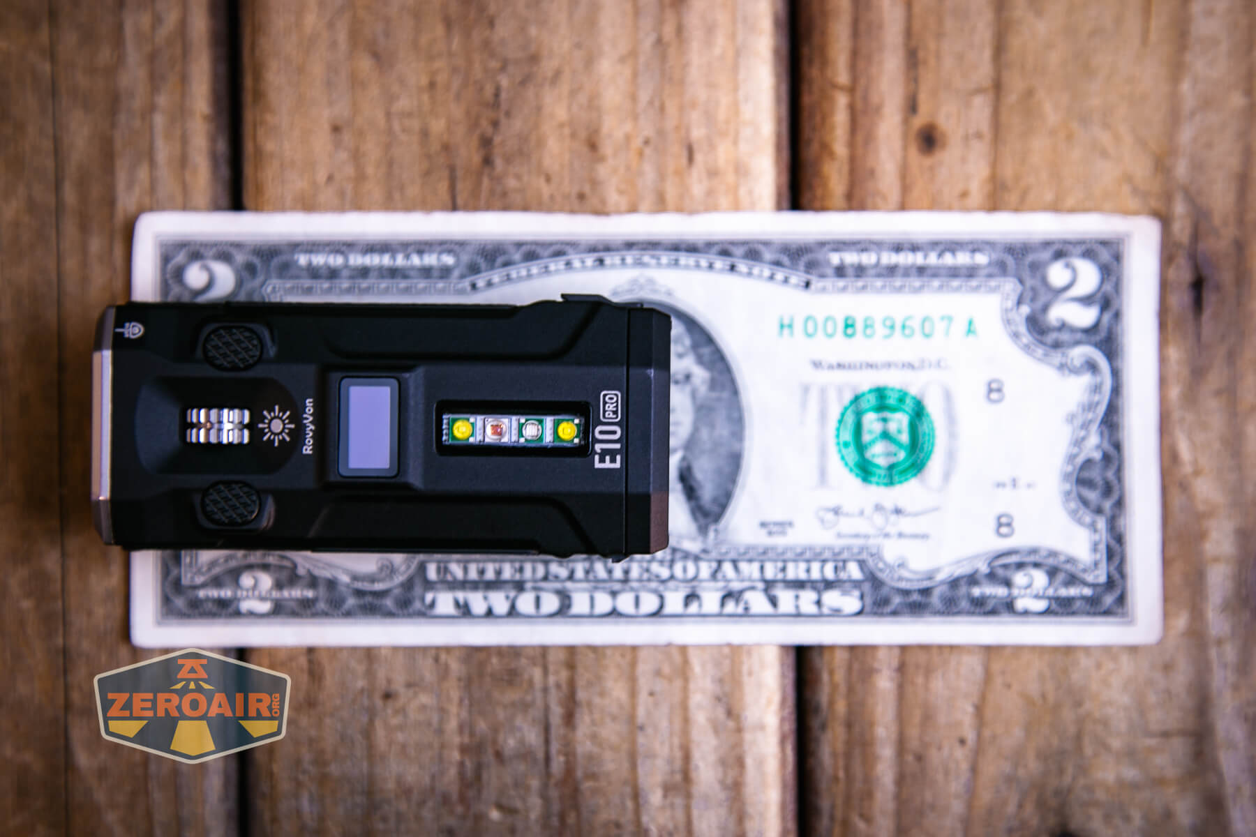 RovyVon E10 Pro flashlight on two-dollar bill