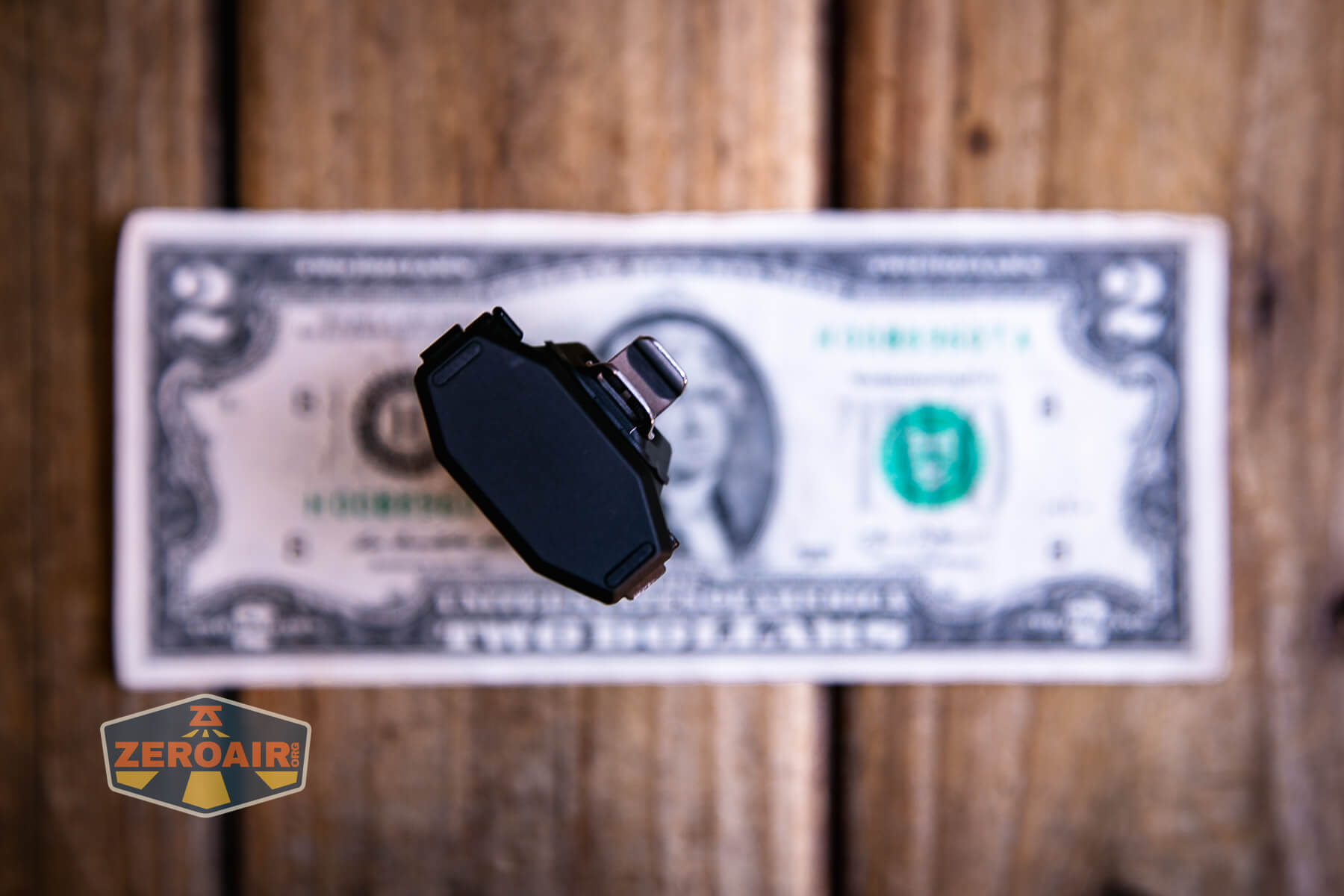 RovyVon E10 Pro flashlight on two-dollar bill