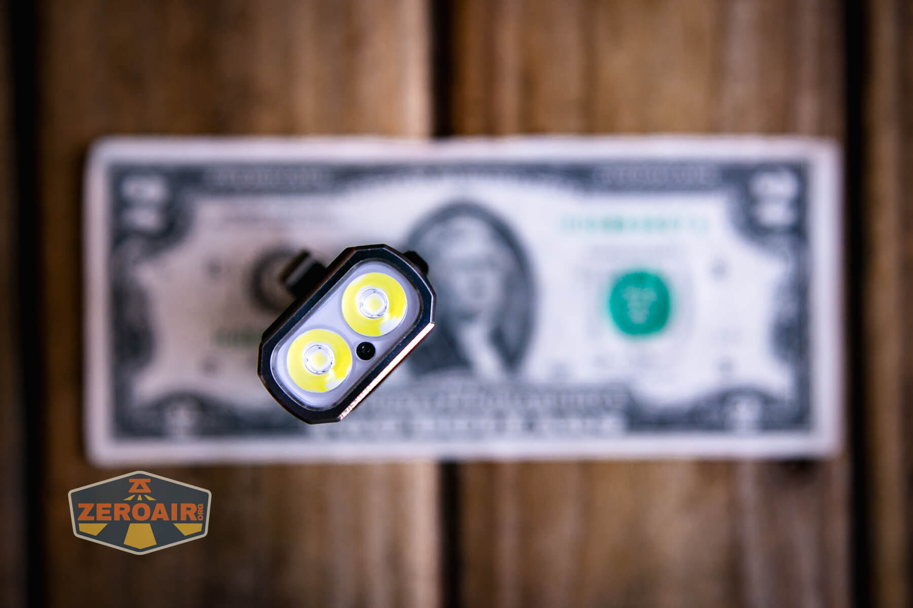 Trustfire Mini X3 Pro EDC multi-function flashlight on a two dollar bill
