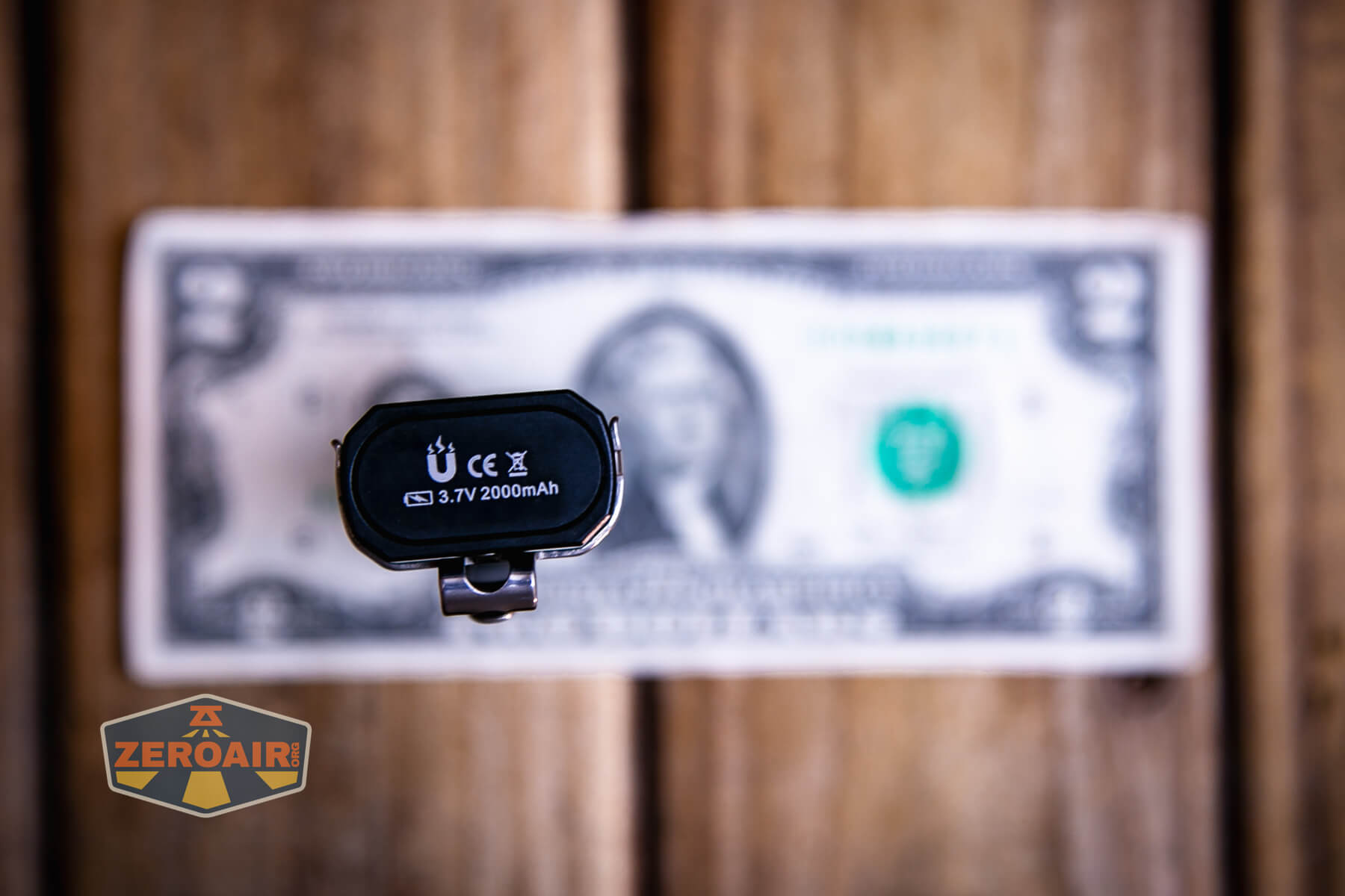 Trustfire Mini X3 Pro EDC multi-function flashlight on a two dollar bill