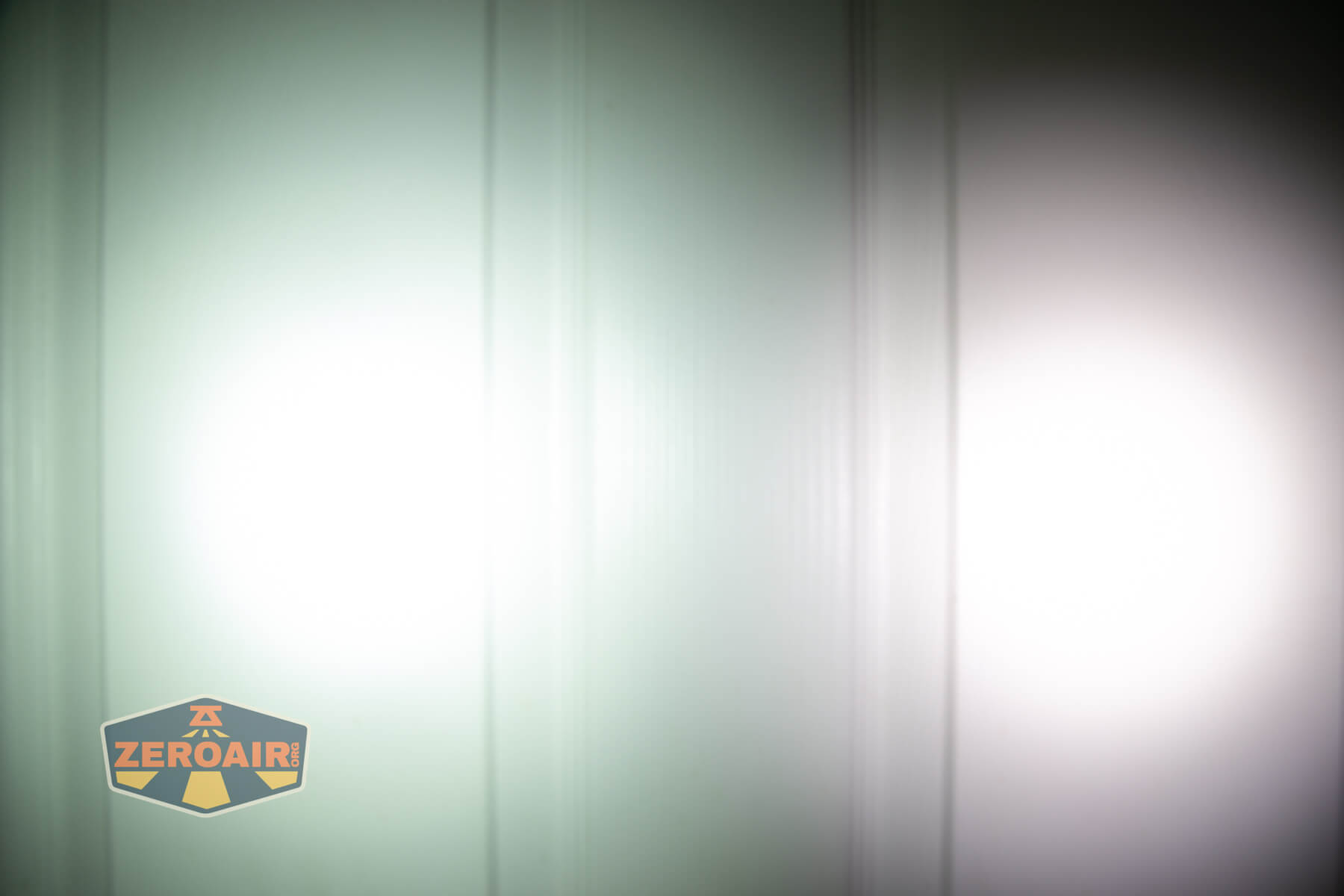 Vastlite i7 10440 flashlight beamshots on door (at 1') compared to nichia 219b 4500K