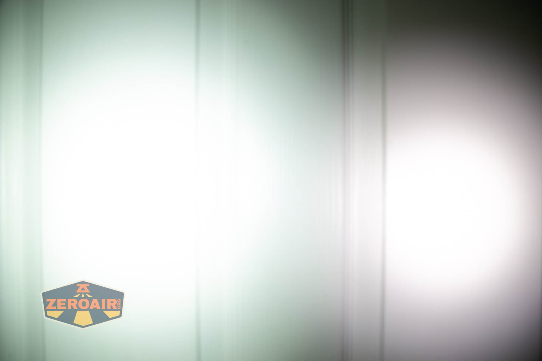 Vastlite i7 10440 flashlight beamshots on door (at 1') compared to nichia 219b 4500K