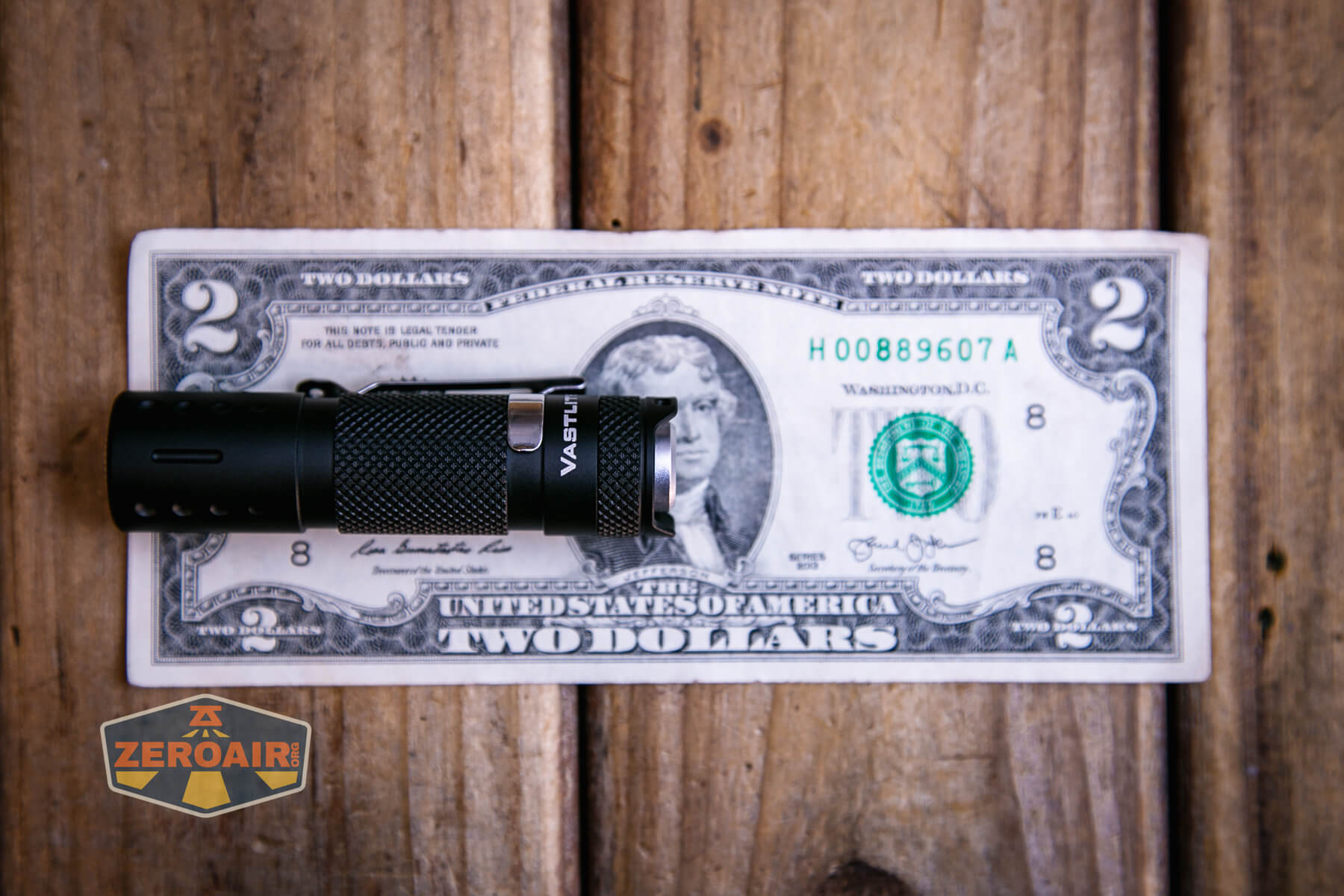 Vastlite Minima BOW LED flashlight on a two-dollar bill