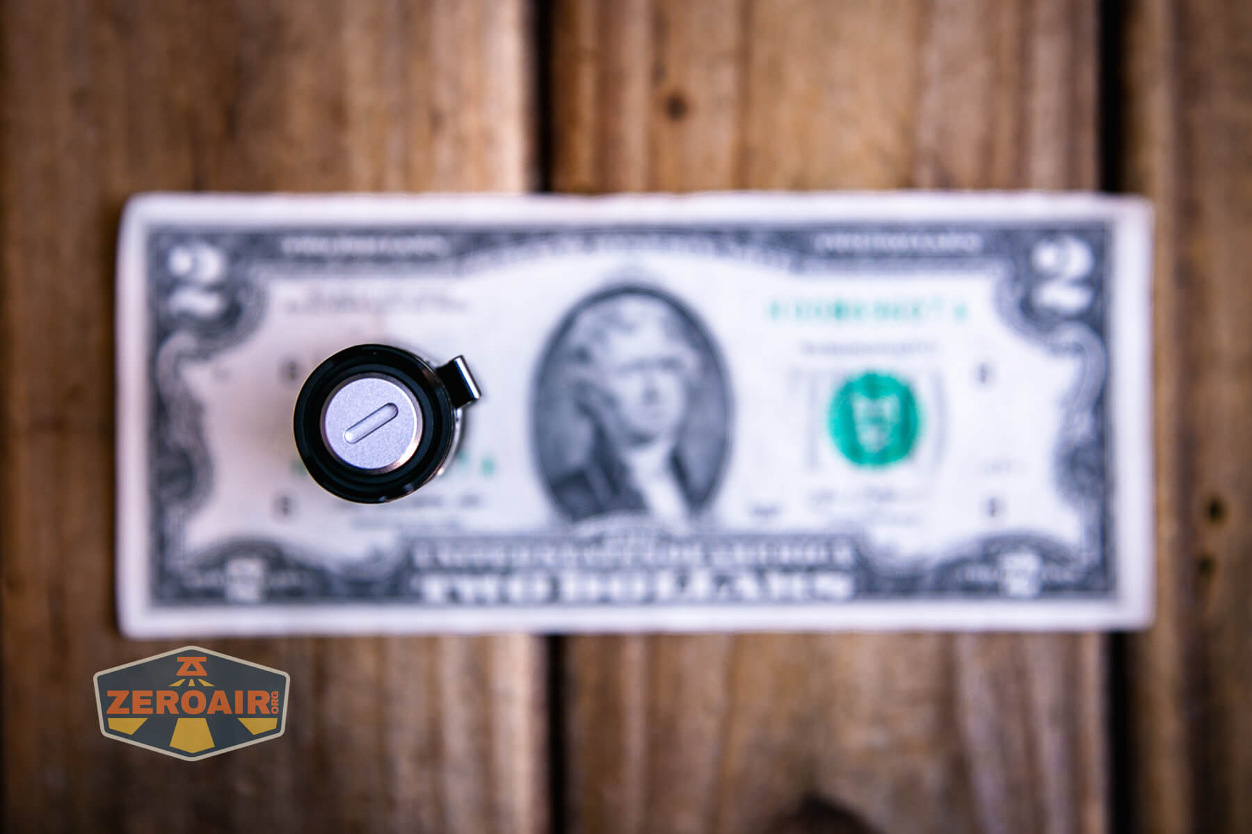 Vastlite Minima BOW LED flashlight on a two-dollar bill