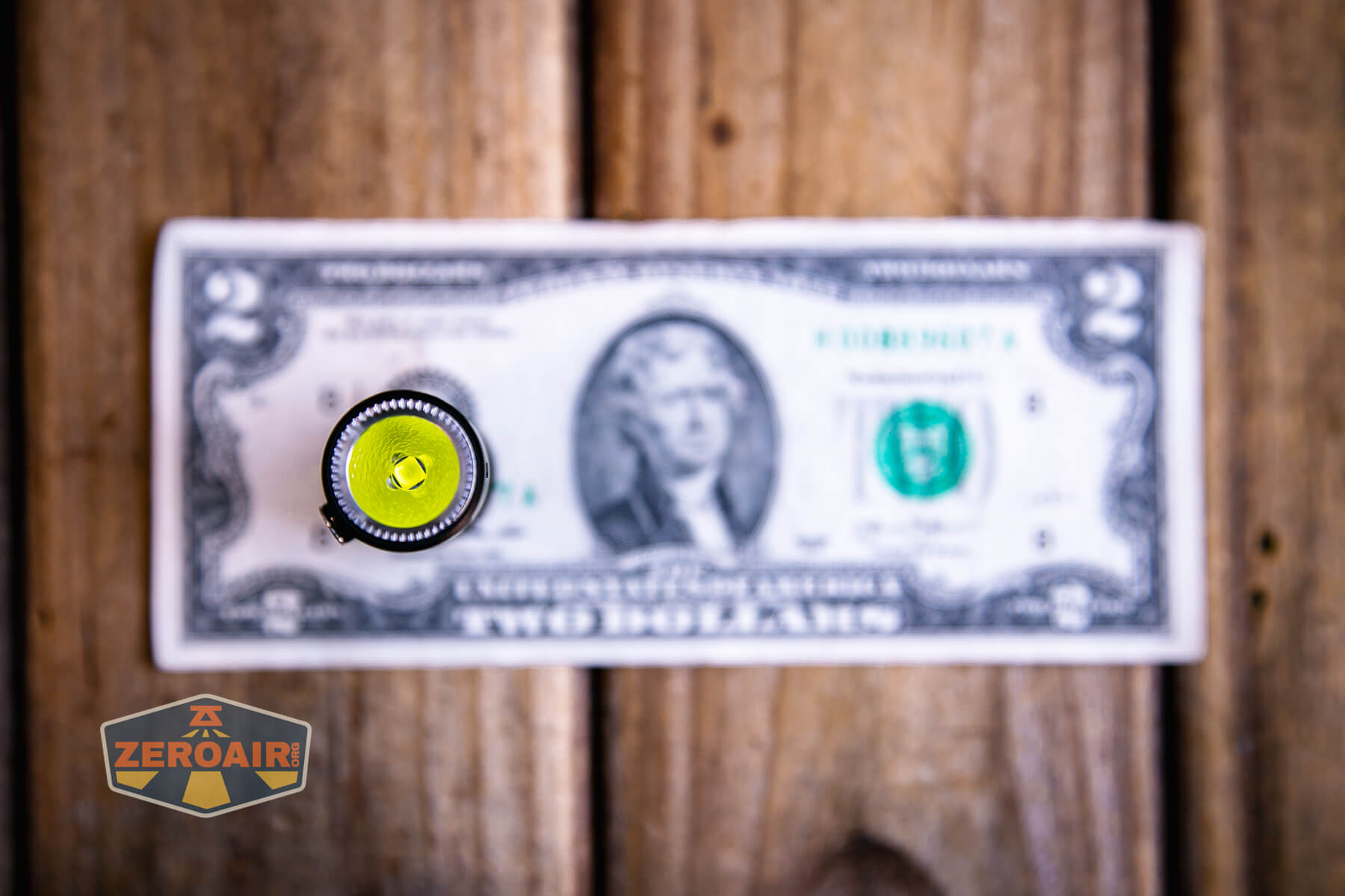 Vastlite Minima BOW LED flashlight on a two-dollar bill