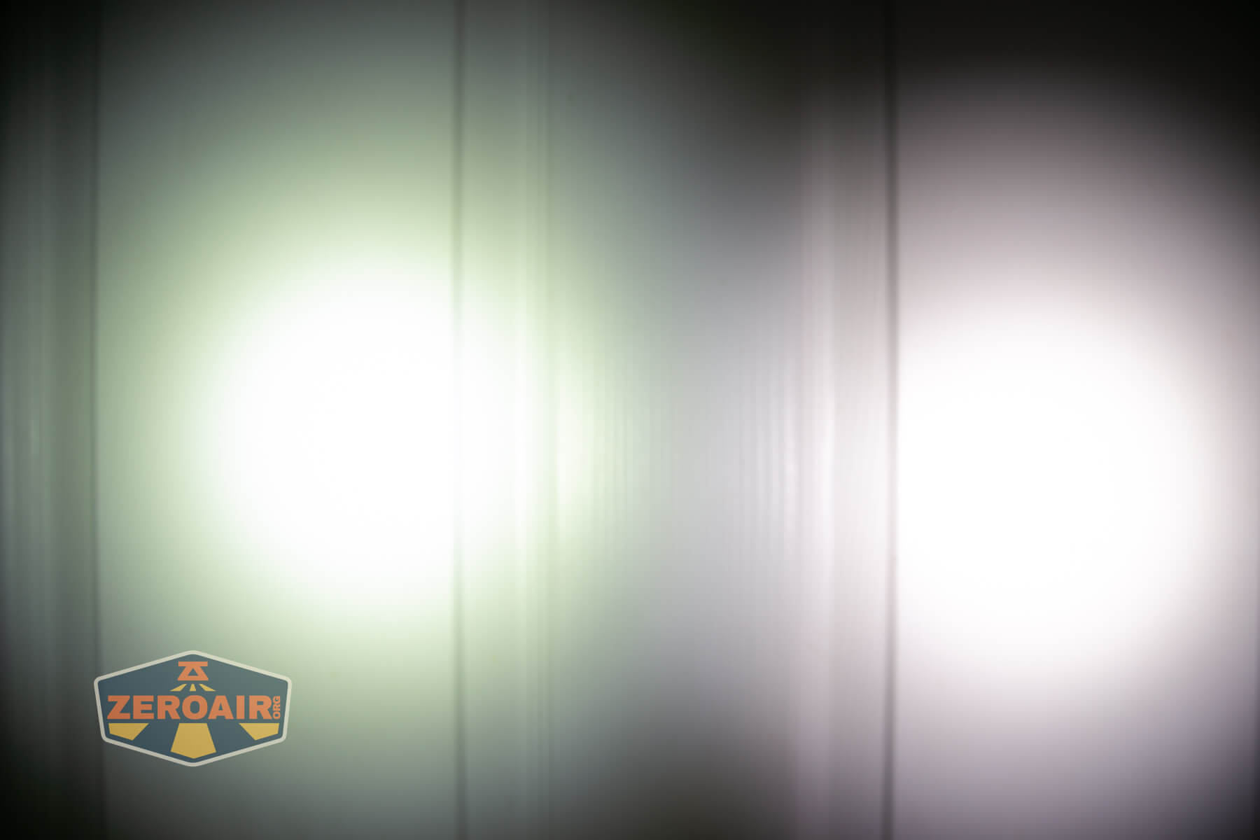 Vastlite Minima BOW LED flashlight beamshots on door compared to Nichia 219b