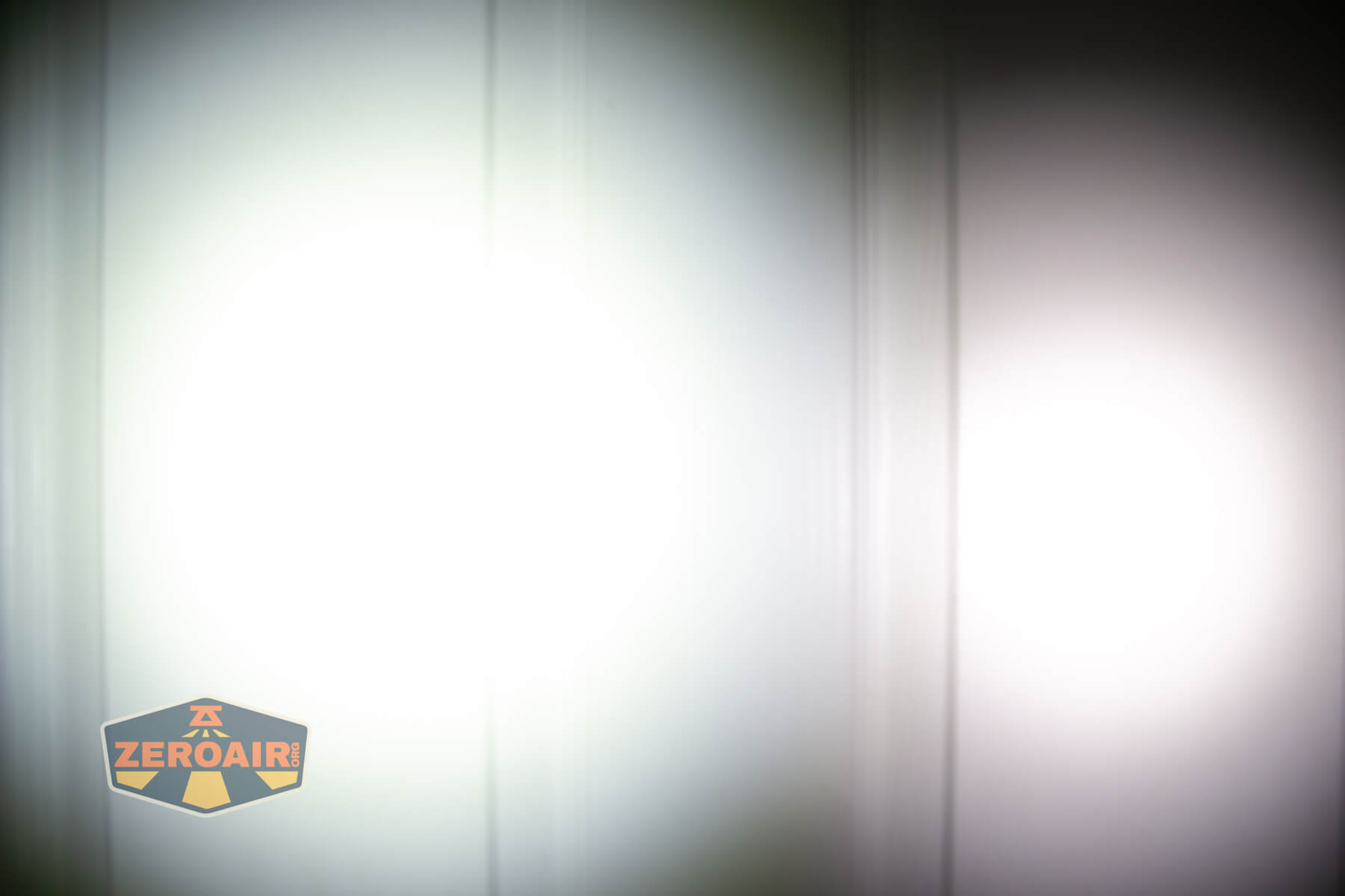 Vastlite Minima BOW LED flashlight beamshots on door compared to Nichia 219b