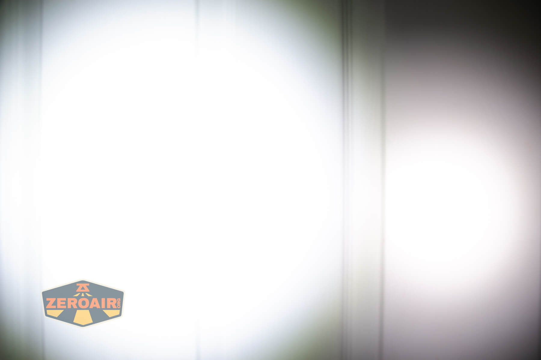 Vastlite Minima BOW LED flashlight beamshots on door compared to Nichia 219b