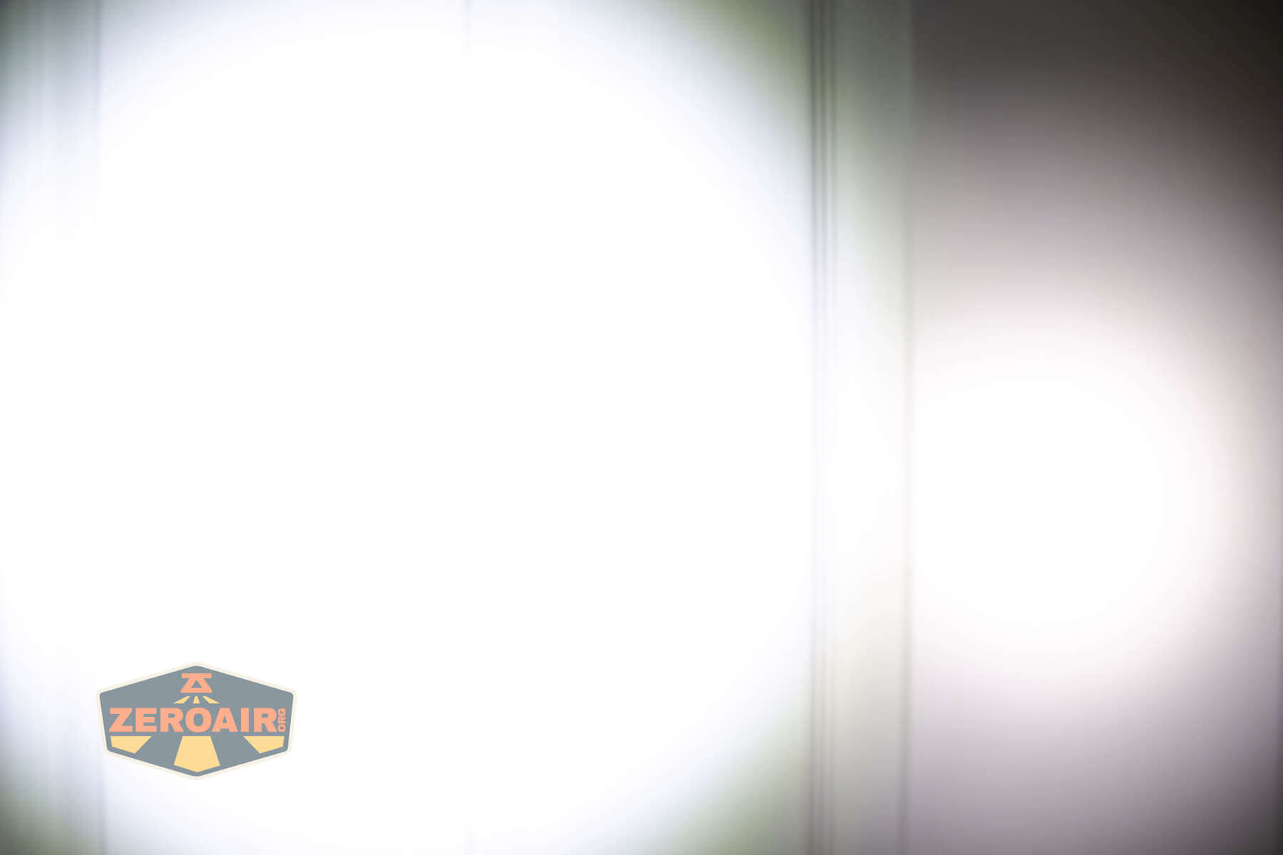 Vastlite Minima BOW LED flashlight beamshots on door compared to Nichia 219b