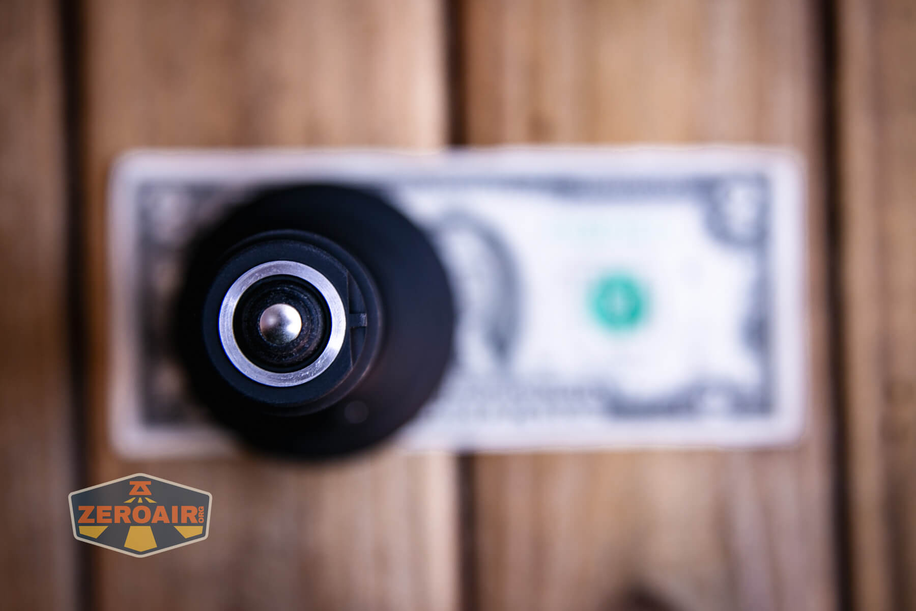 Armytek Barracuda Pro Max searchlight on two dollar bill