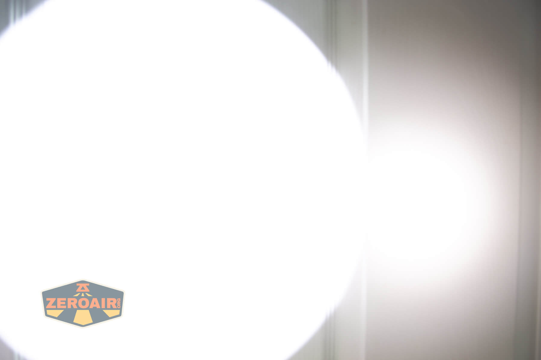 Armytek Barracuda Pro Max searchlight beamshots on door compared to nichia 219b