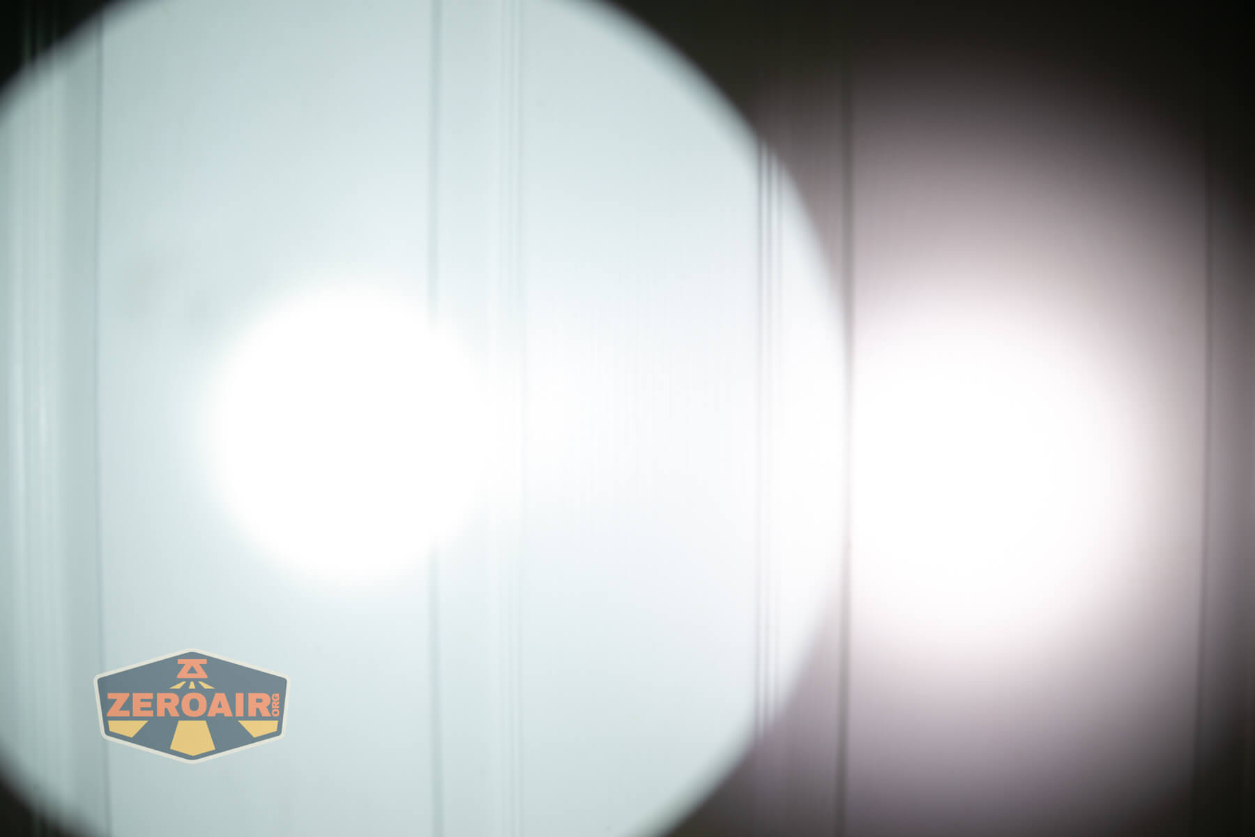 Armytek Barracuda Pro Max searchlight beamshots on door compared to nichia 219b