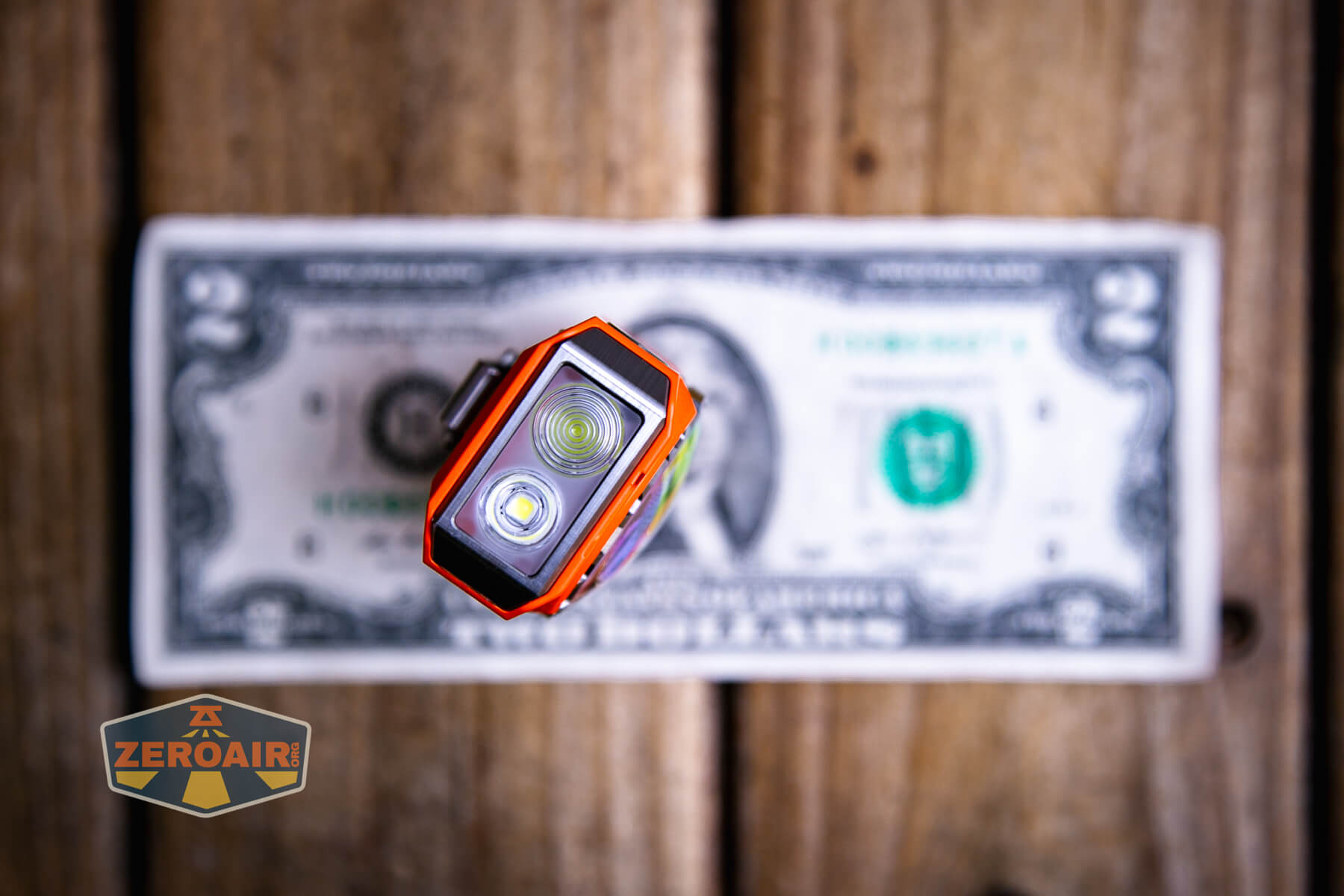 Mateminco TACUBE 3.0 multi-function RGB flashlight on a two dollar bill