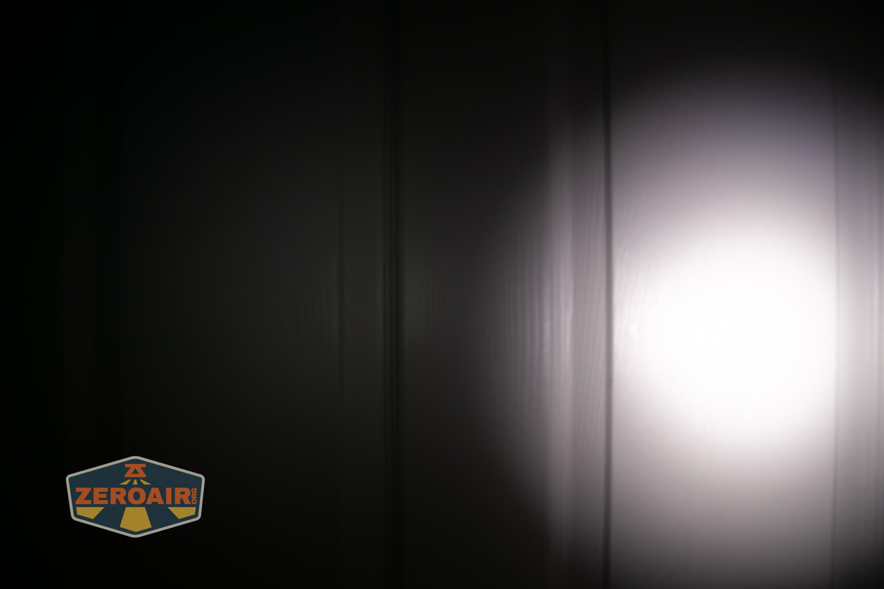 Nitecore TIP3 keychain flashlight beamshots on door (at 1') compared to nichia 219b 4500K