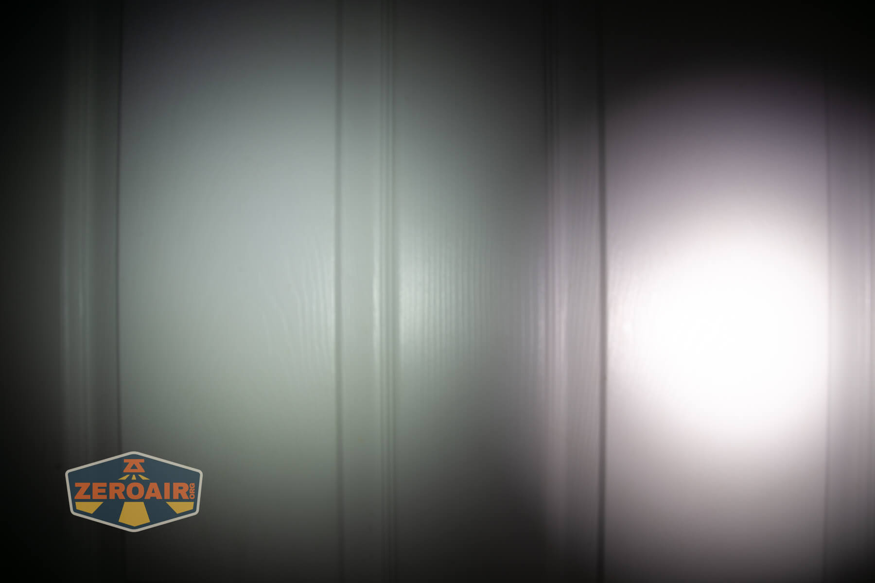 Nitecore TIP3 keychain flashlight beamshots on door (at 1') compared to nichia 219b 4500K