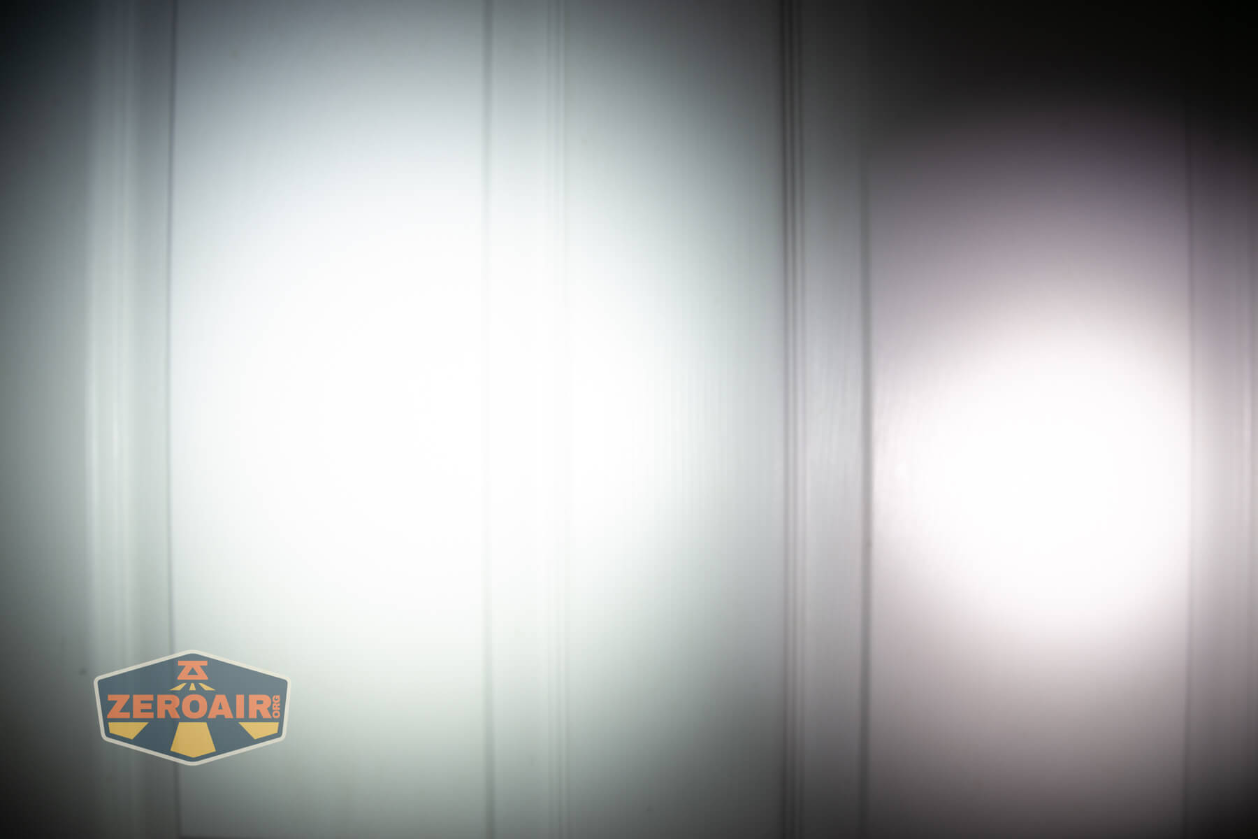 Nitecore TIP3 keychain flashlight beamshots on door (at 1') compared to nichia 219b 4500K