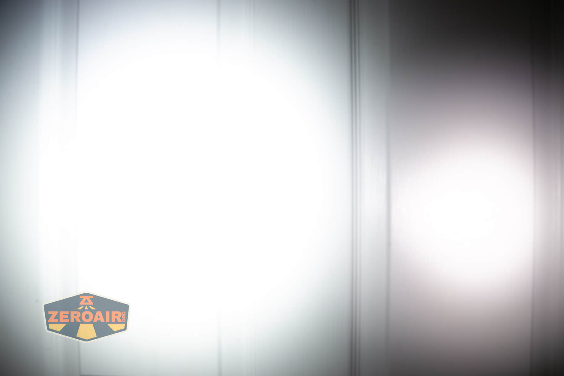 Nitecore TIP3 keychain flashlight beamshots on door (at 1') compared to nichia 219b 4500K