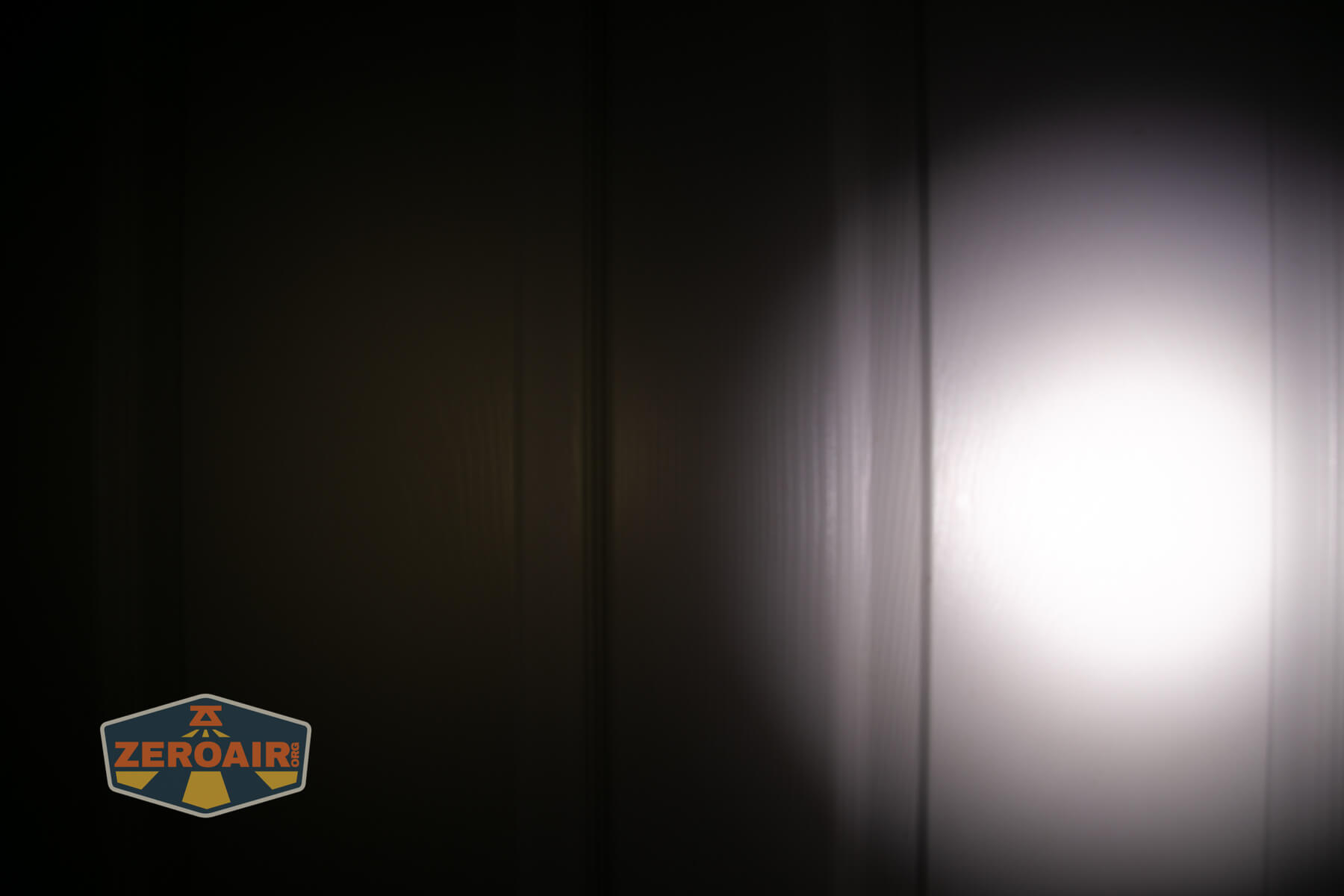 Nitecore TIP3 keychain flashlight beamshots on door (at 1') compared to nichia 219b 4500K
