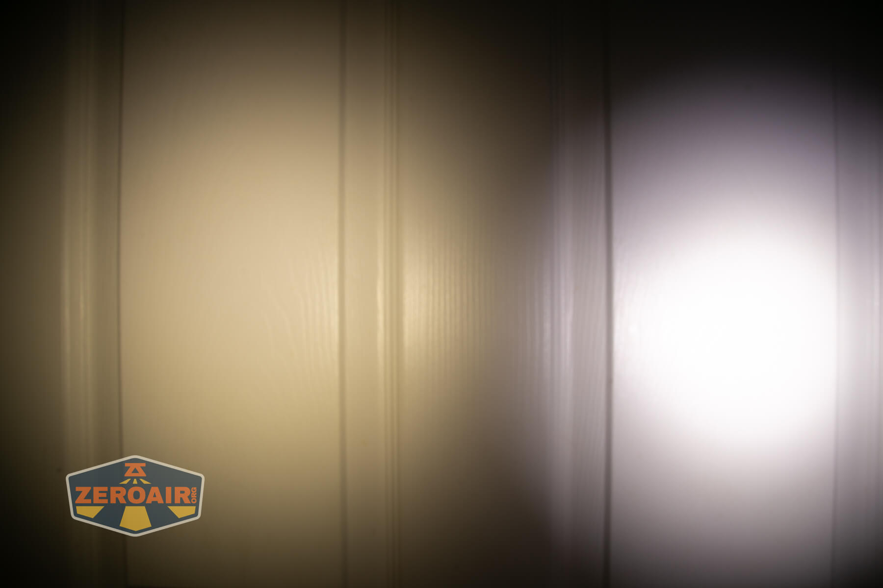 Nitecore TIP3 keychain flashlight beamshots on door (at 1') compared to nichia 219b 4500K
