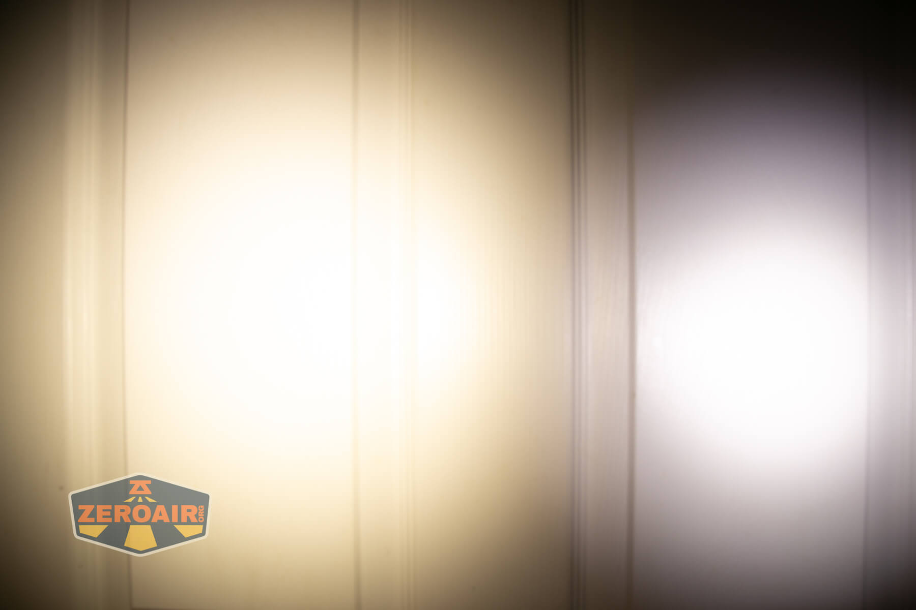 Nitecore TIP3 keychain flashlight beamshots on door (at 1') compared to nichia 219b 4500K