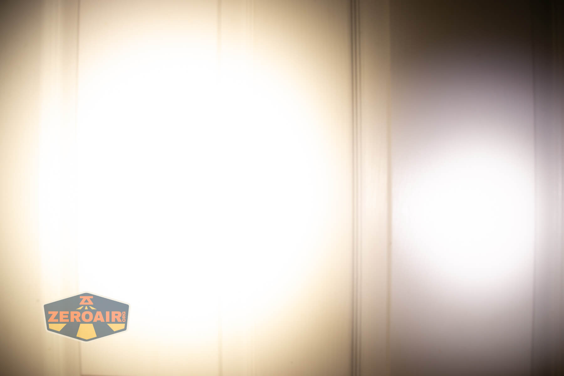 Nitecore TIP3 keychain flashlight beamshots on door (at 1') compared to nichia 219b 4500K