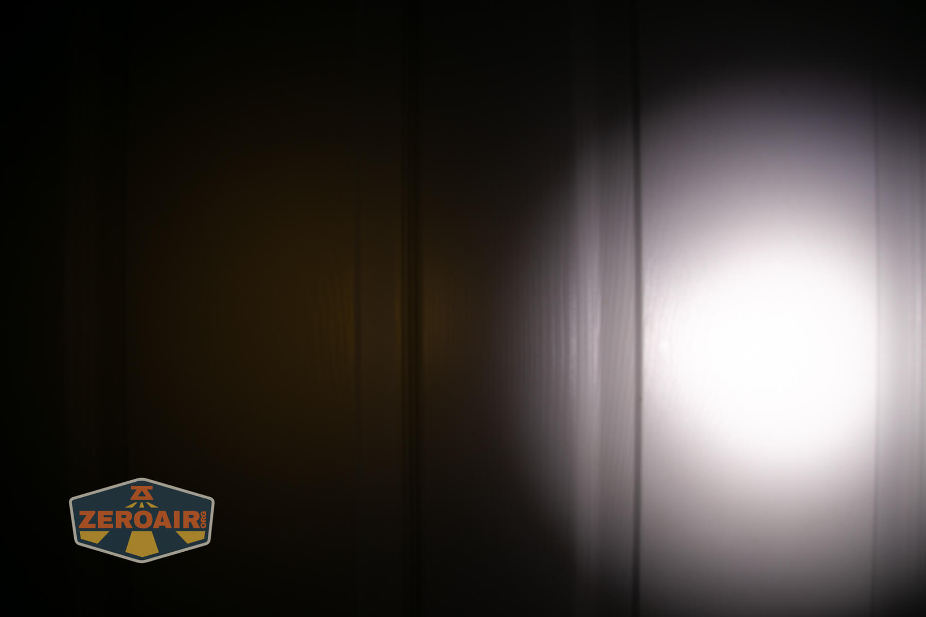 Nitecore TIP3 keychain flashlight beamshots on door (at 1') compared to nichia 219b 4500K