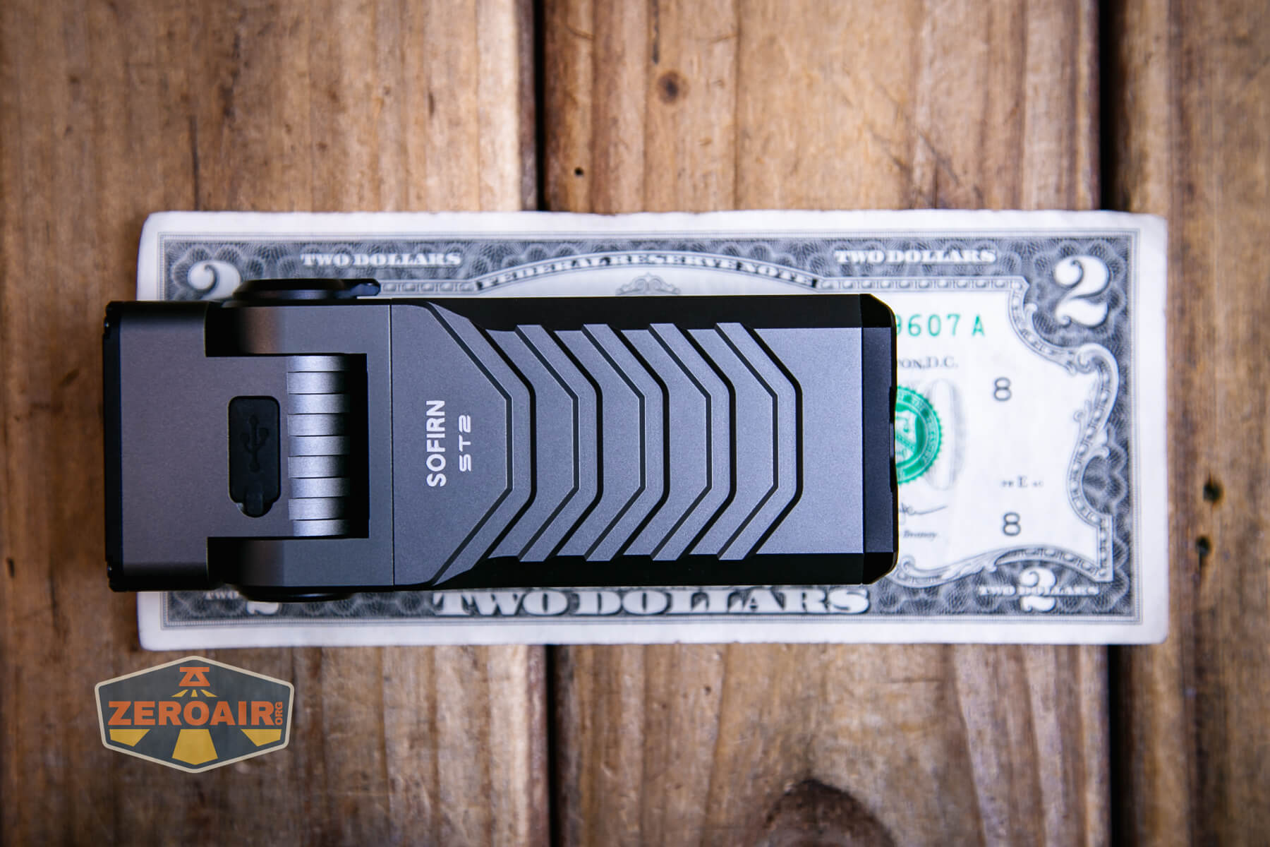 Sofirn ST2 multi-function flat flashlight on a two dollar bill