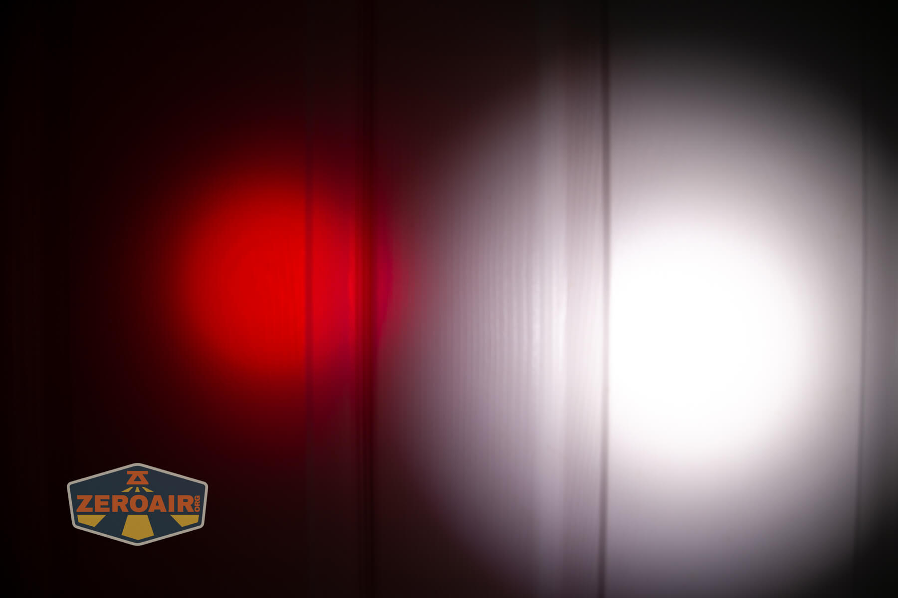 Sofirn ST2 multi-function flat flashlight beamshots on door (at 1') compared to nichia 219b 4500K
