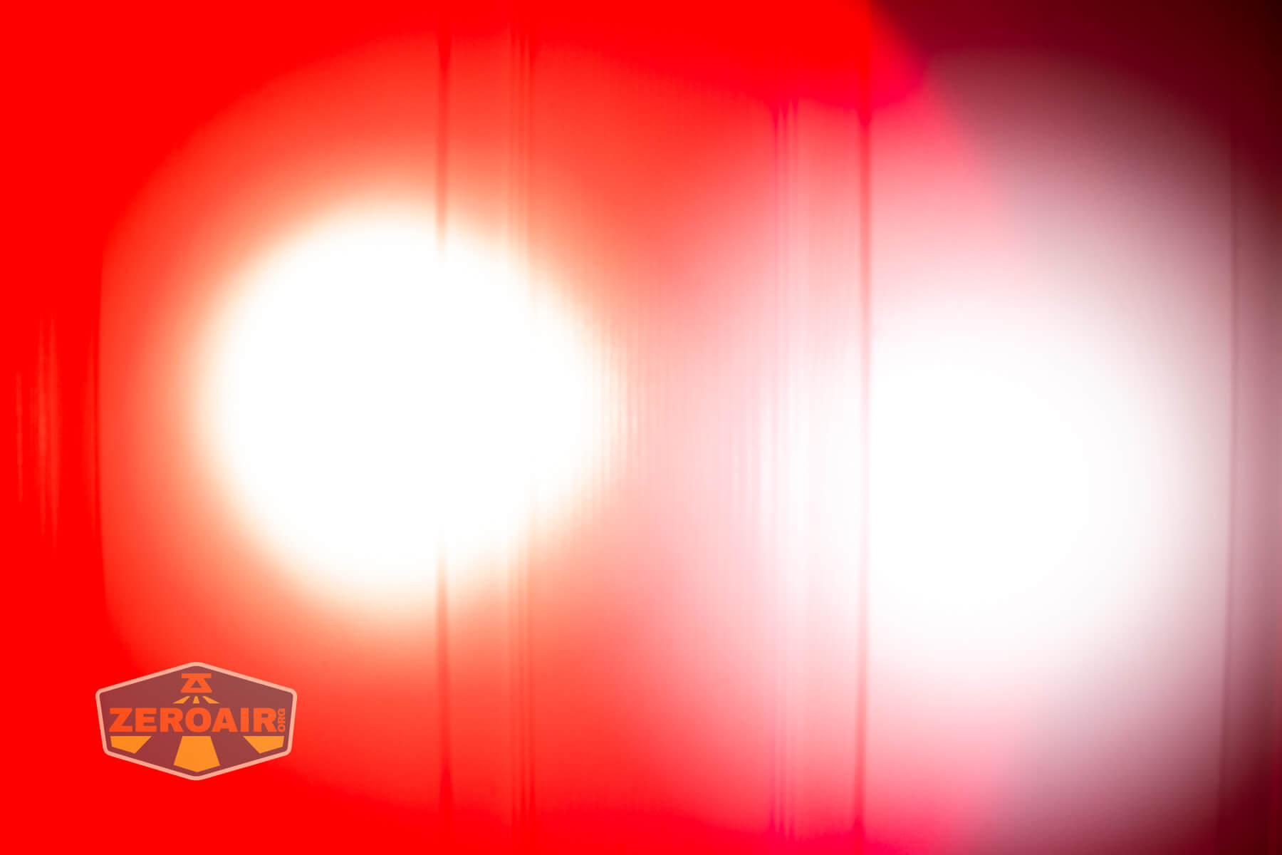 Sofirn ST2 multi-function flat flashlight beamshots on door (at 1') compared to nichia 219b 4500K
