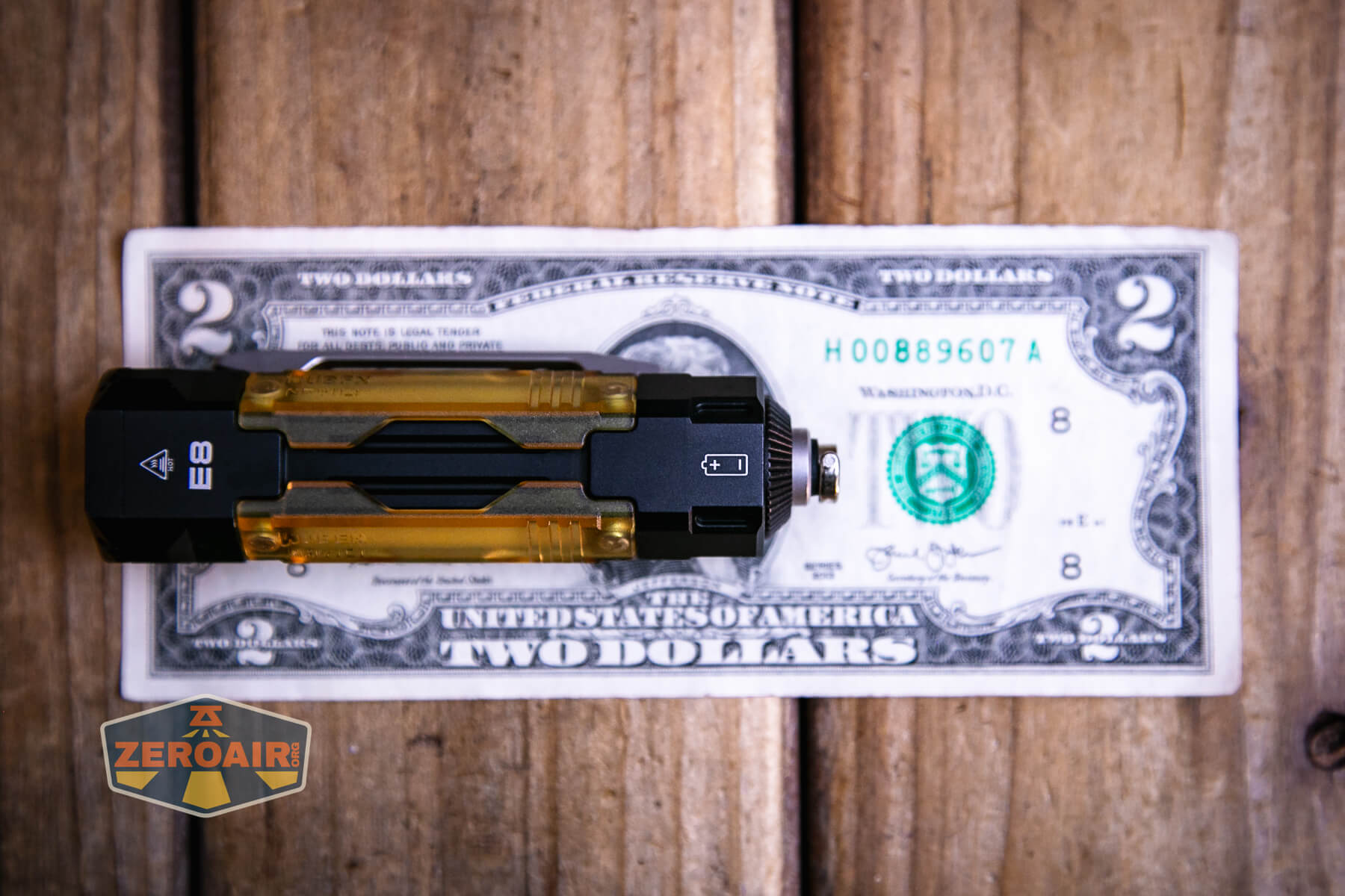 Wuben E Production Flashlight on two dollar bill