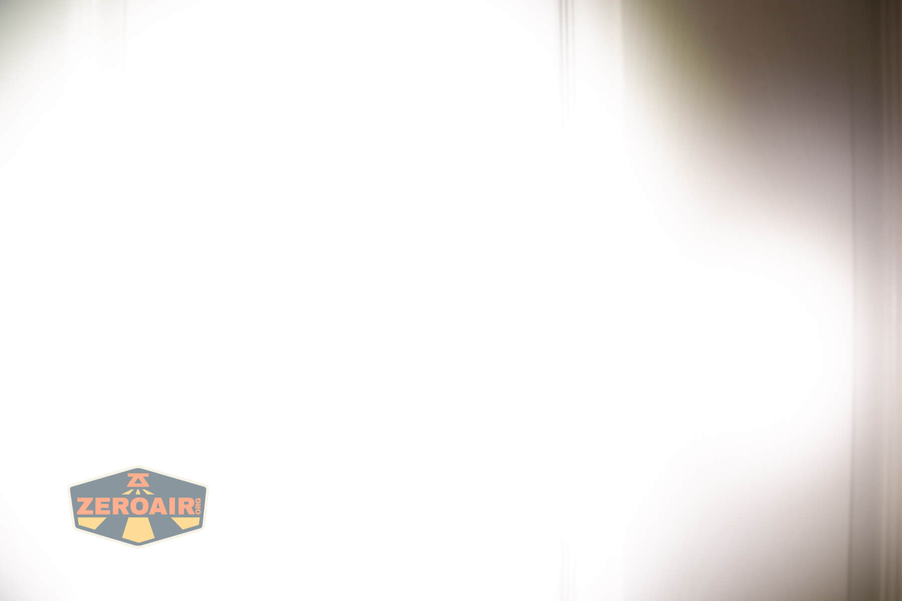 Wuben E Production flashlight beamshots on door compared to Nichia 219bA