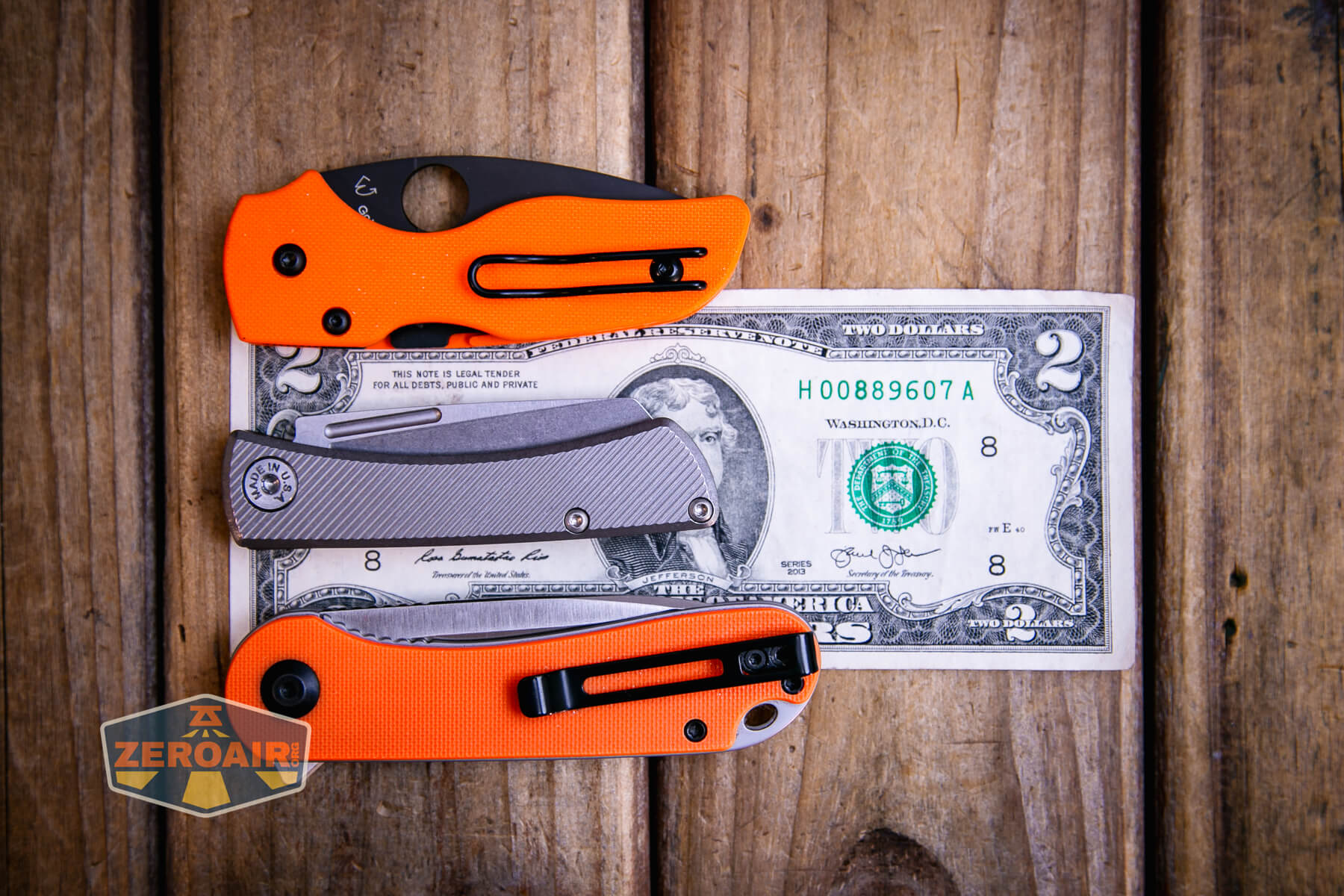 American Blade Works Slip joint on a two dollar bill compared to Civivi Elementum in orange
