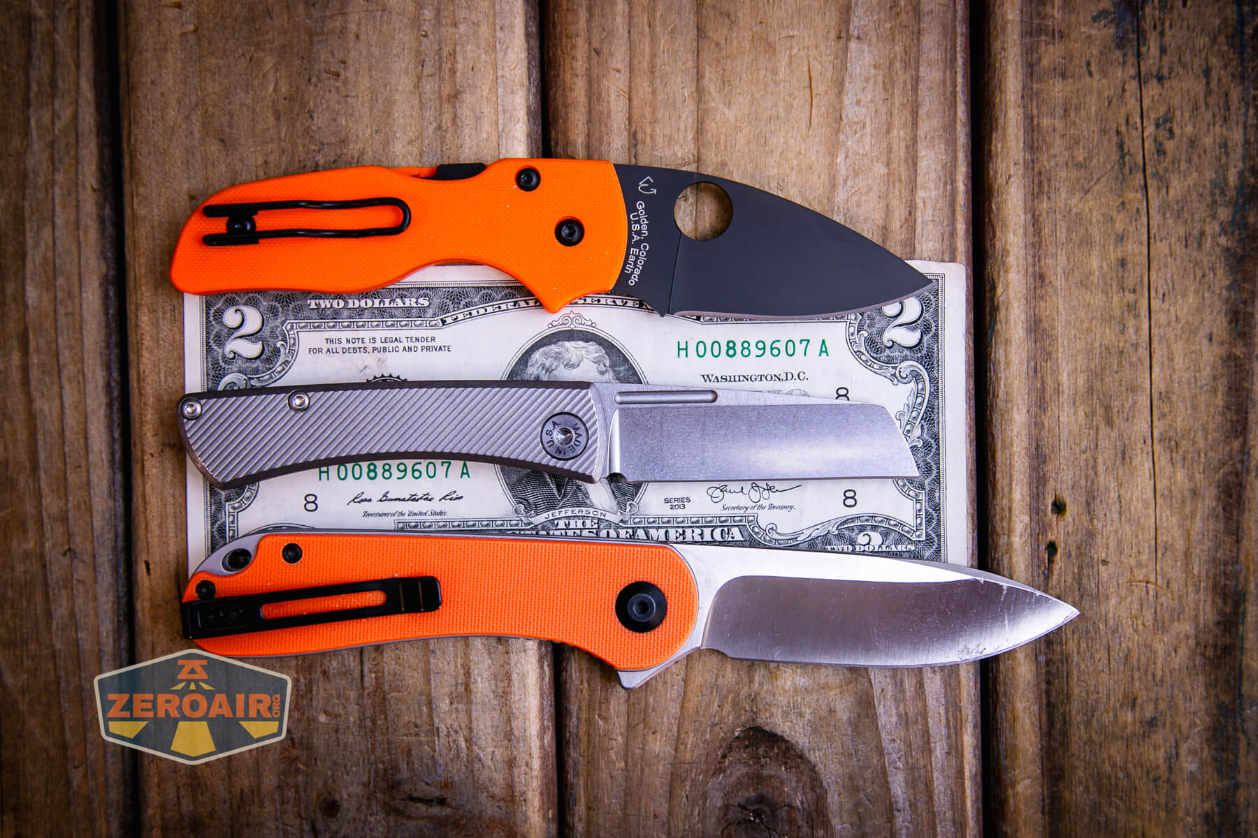 American Blade Works Slip joint on a two dollar bill compared to Civivi Elementum in orange