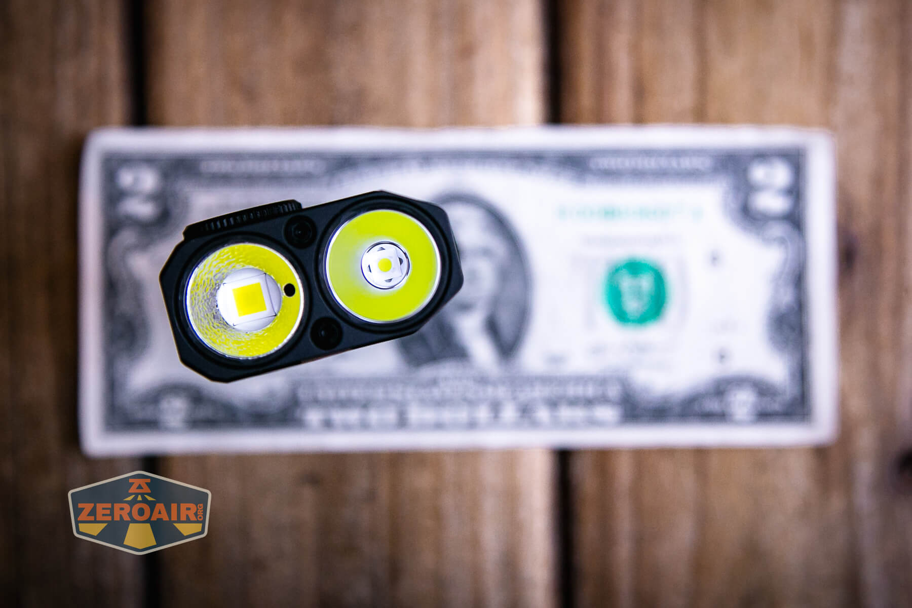 JETBeam E28 EDC Multi-mode Flat Tactical flashlight on a two dollar bill