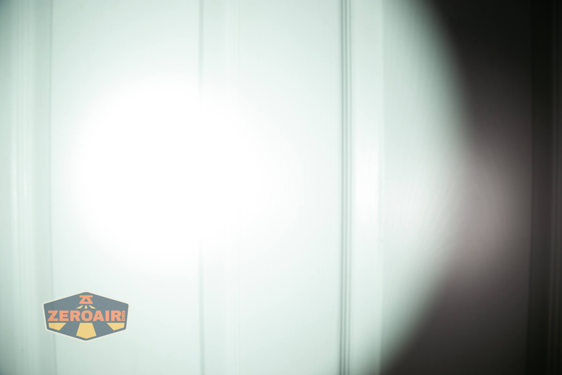 JETBeam E28 EDC Multi-mode Flat Tactical flashlight beamshots on door (at 1') compared to nichia 219b 4500K