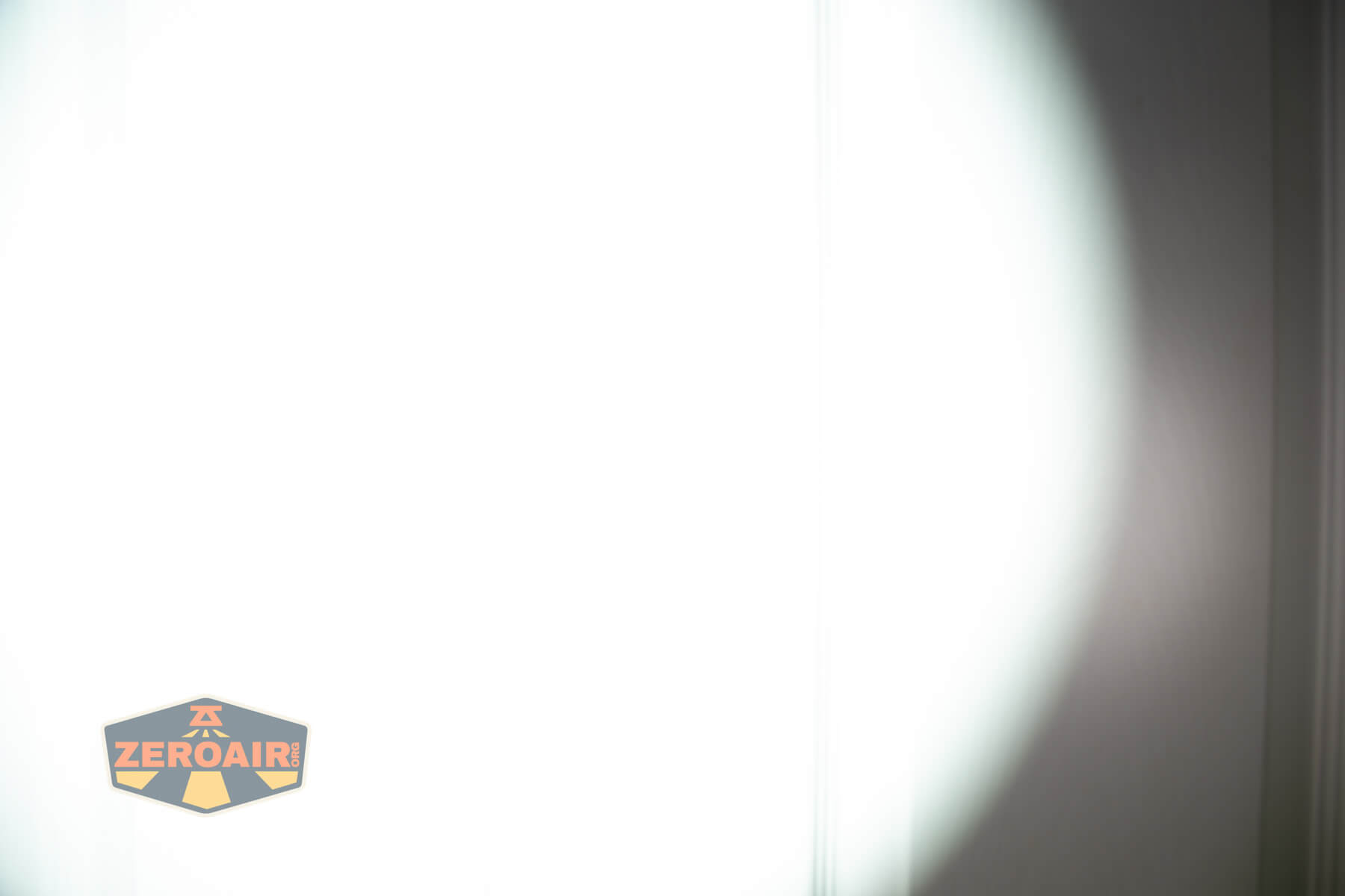 JETBeam E28 EDC Multi-mode Flat Tactical flashlight beamshots on door (at 1') compared to nichia 219b 4500K