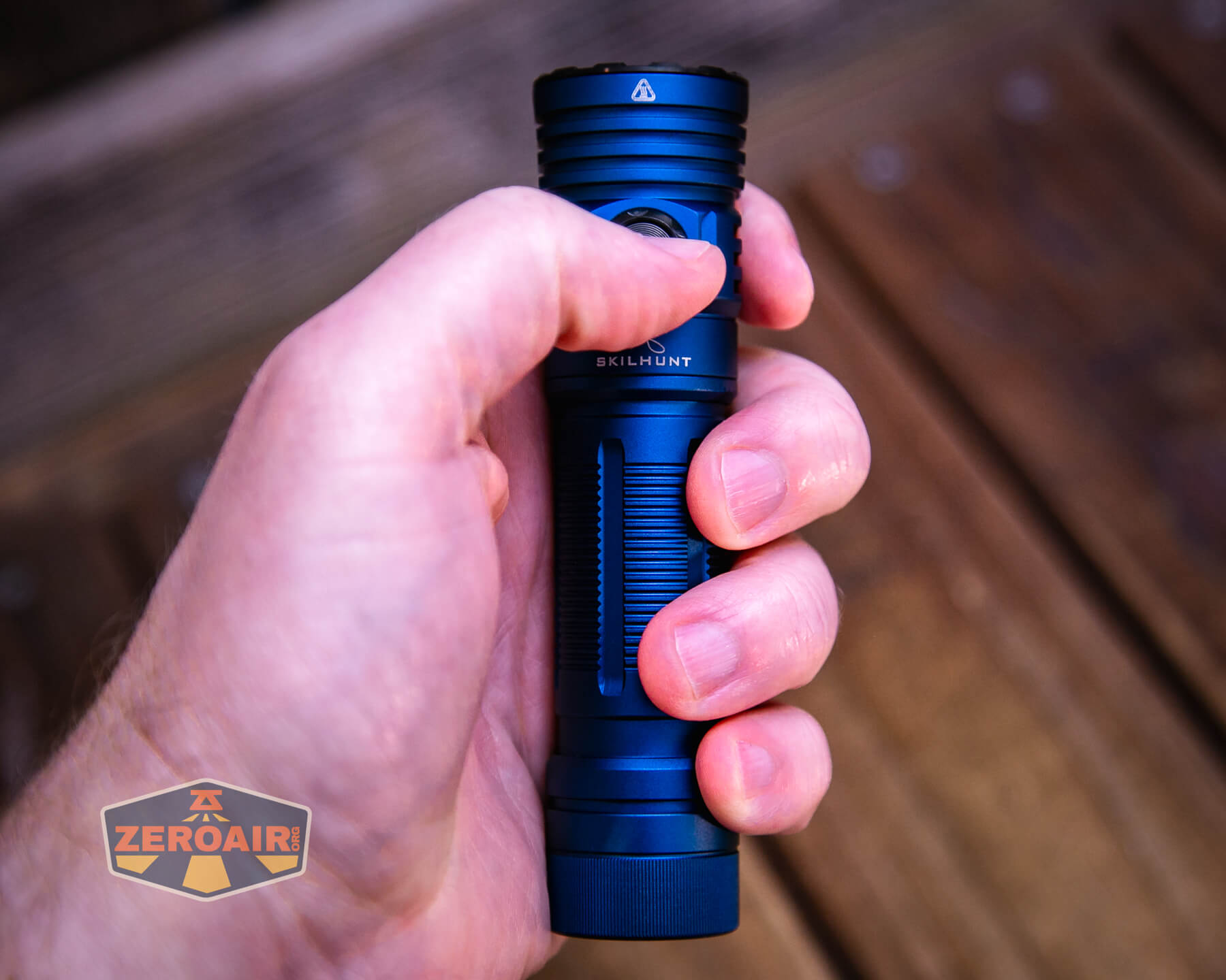 Skilhunt M300 V4 blue flashlight in hand