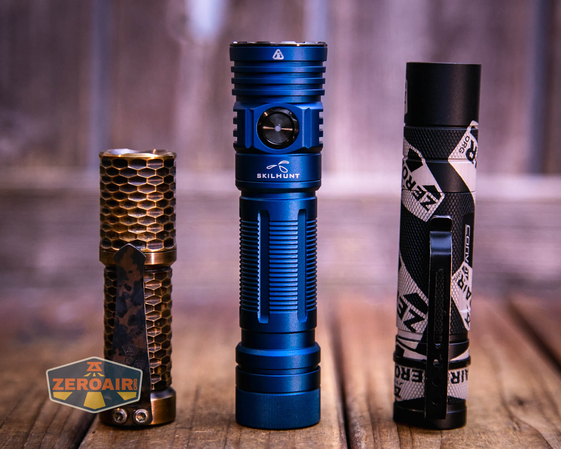 Skilhunt M300 V4 blue flashlight with two standard sized flashlights