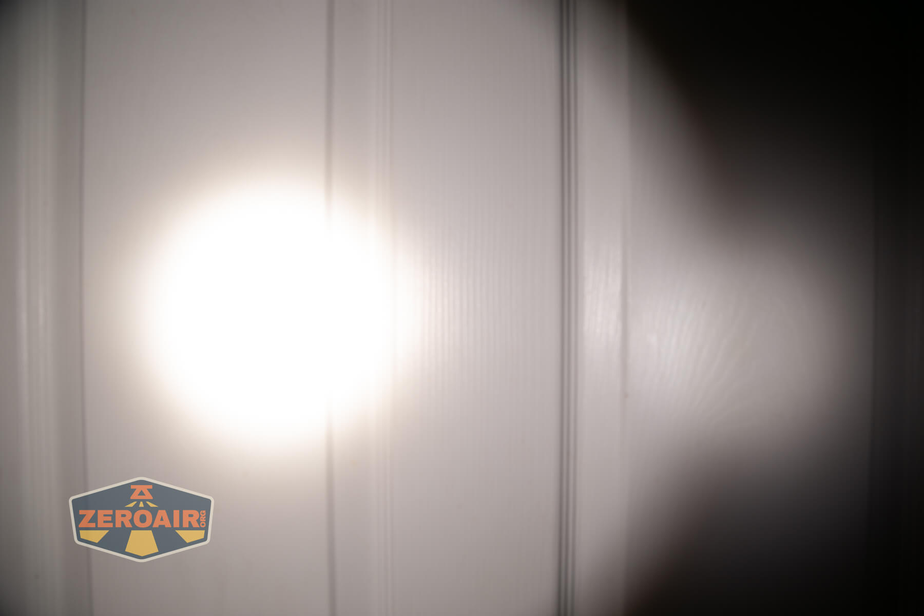 Skilhunt M300 V4 blue flashlight beamshots on door (at 1') compared to nichia 219b 4500K