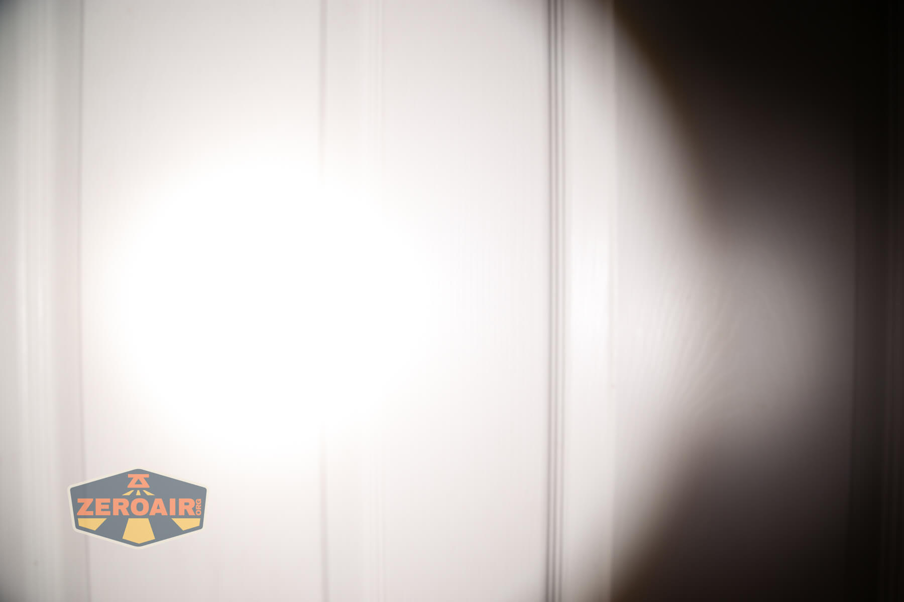 Skilhunt M300 V4 blue flashlight beamshots on door (at 1') compared to nichia 219b 4500K