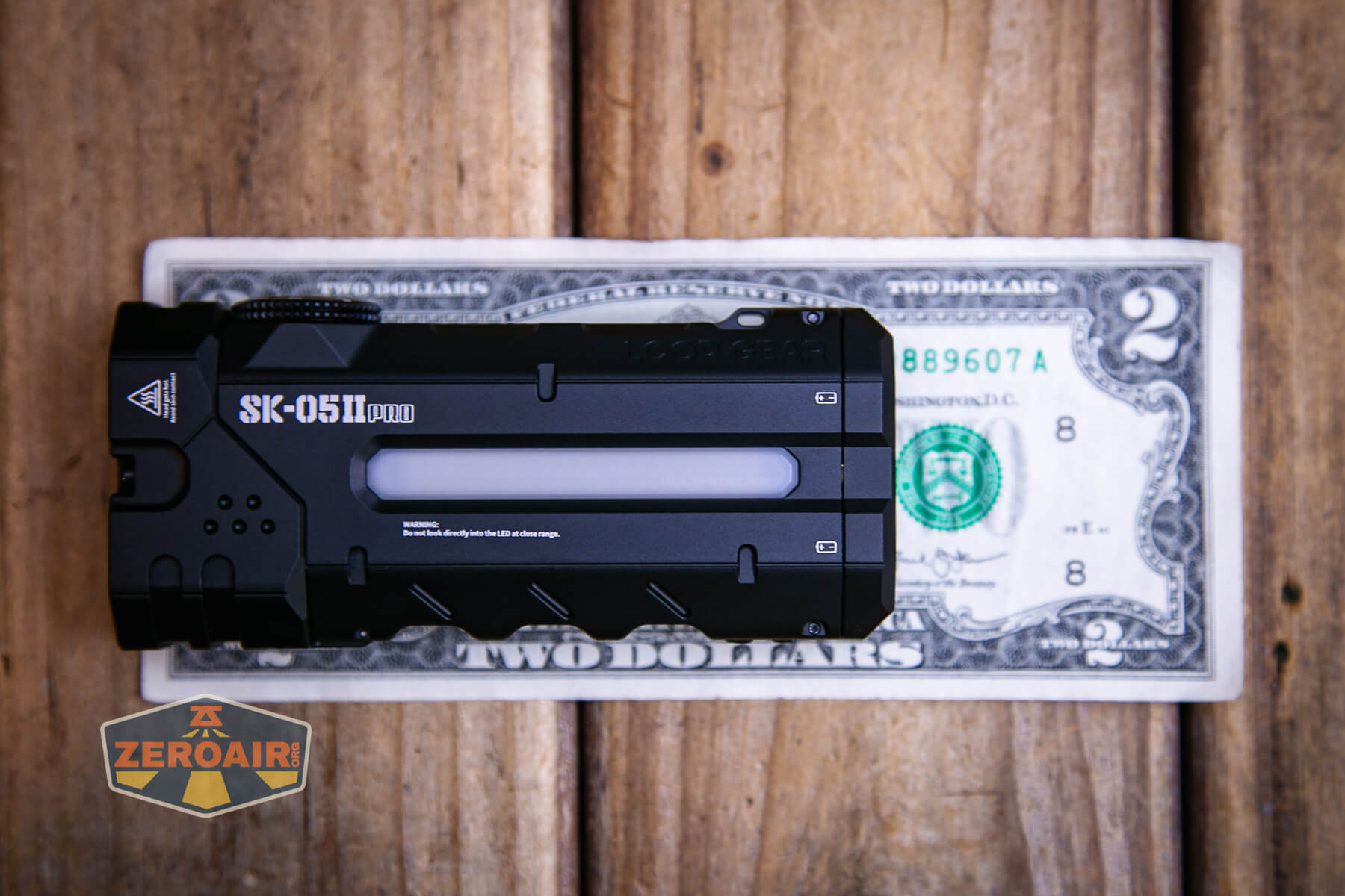 LoopGear SK-05 II Pro flashlight on a two dollar bill