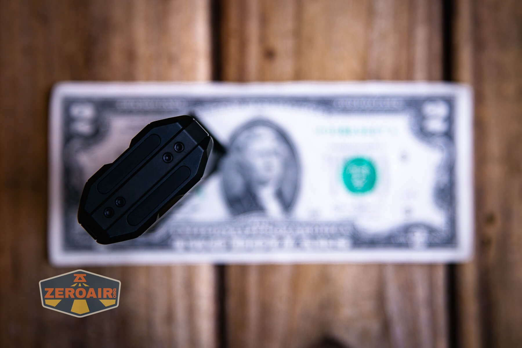 LoopGear SK-05 II Pro flashlight on a two dollar bill