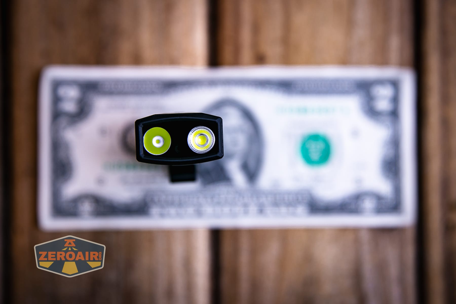 Olight ArkPro Ultra Onyx Black flashlight on a two dollar bill