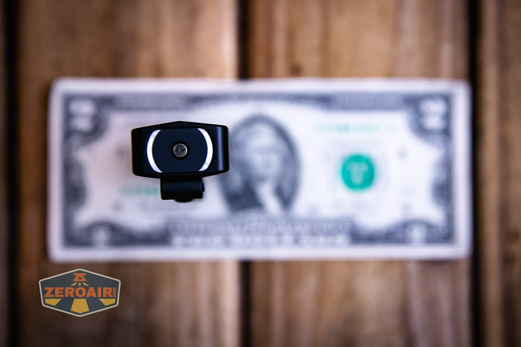 Olight ArkPro Ultra Onyx Black flashlight on a two dollar bill