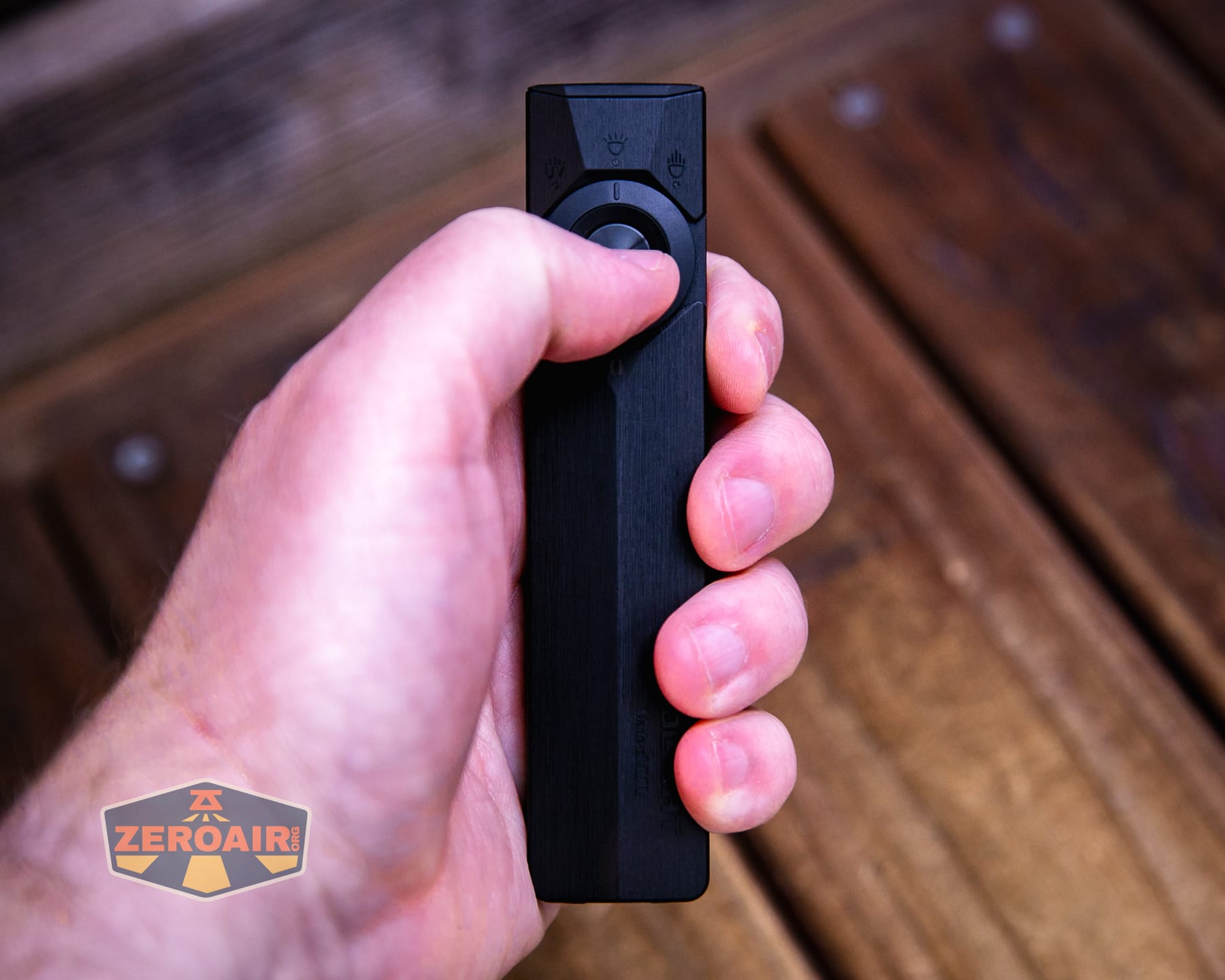 Olight ArkPro Ultra Onyx Black flashlight in hand