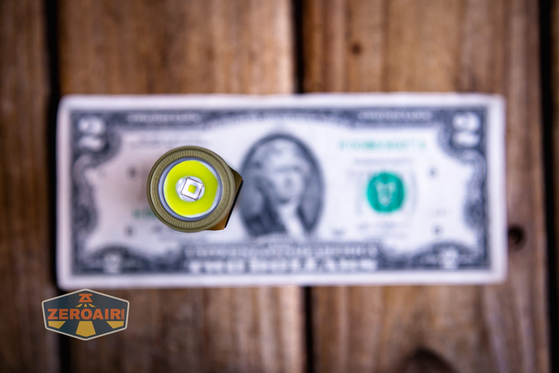 Olight Baton Ultra OAL flashlight on a two dollar bill