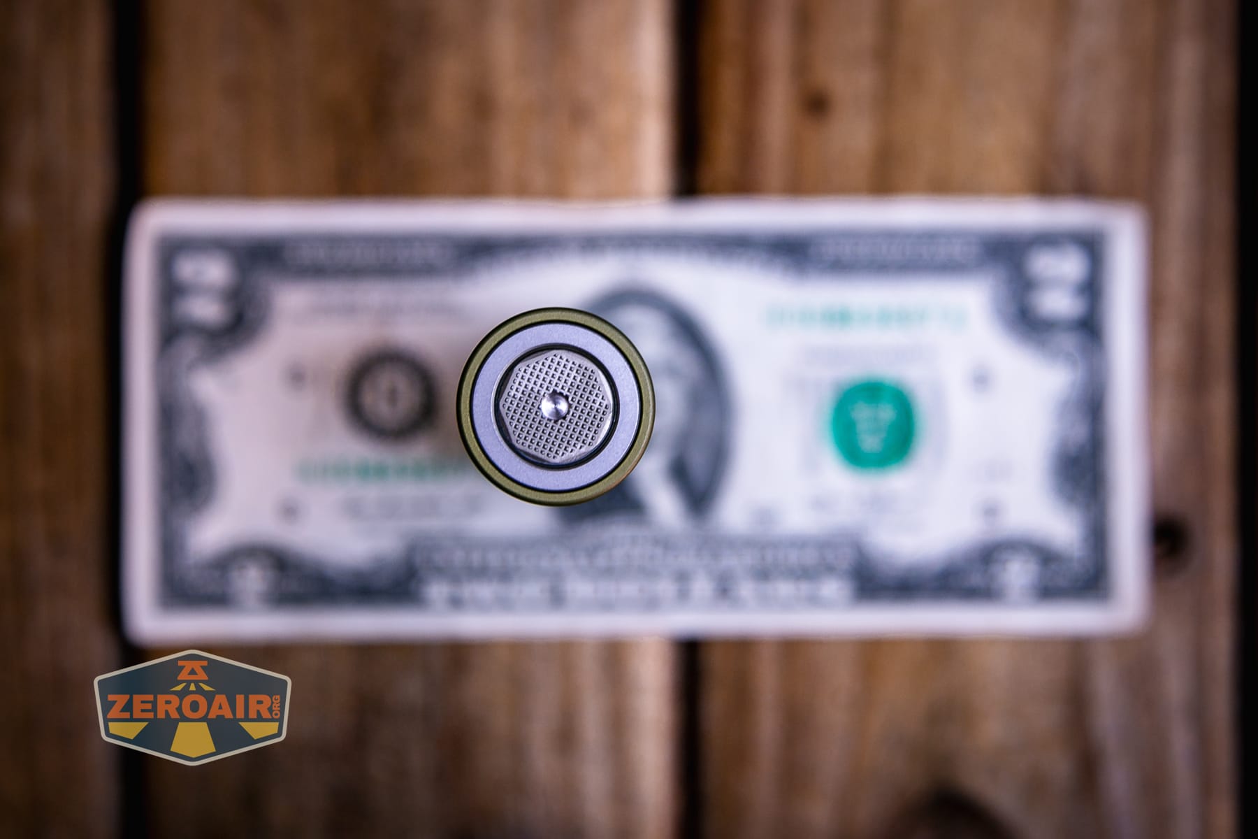 Olight Baton Ultra OAL flashlight on a two dollar bill